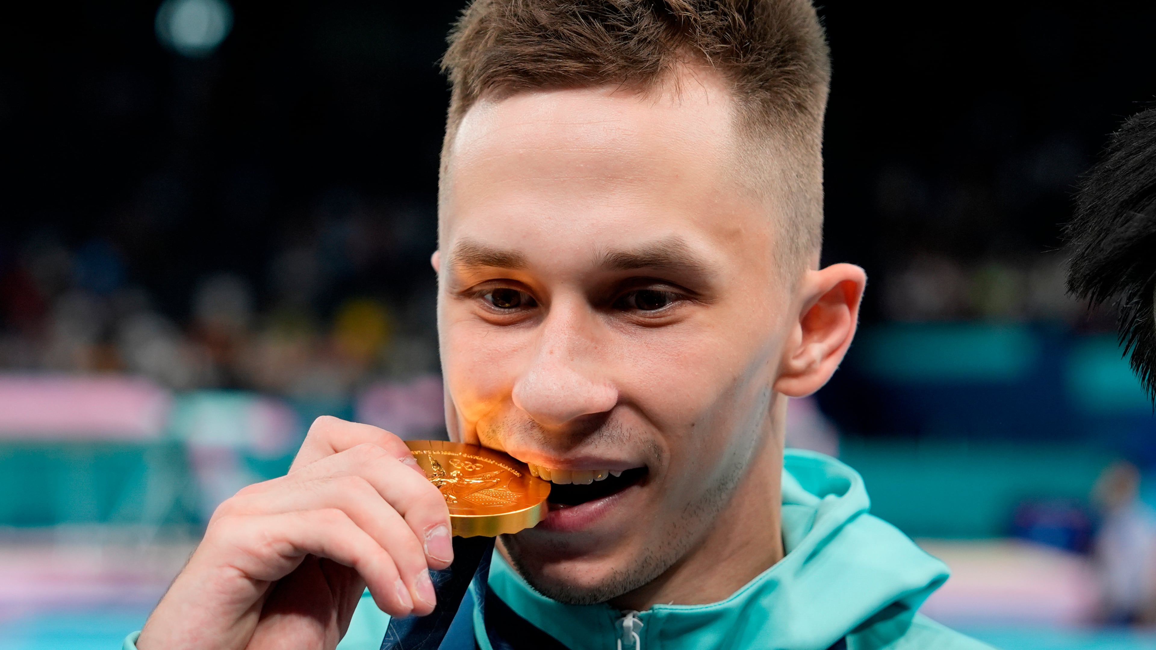 FILE - Ivan Litvinovich of the Individual Neutral Athletes celebrates after winning the gold medal during the men's trampoline finals in Bercy Arena at the 2024 Summer Olympics, Friday, Aug. 2, 2024, in Paris, France. (AP Photo/Charlie Riedel, File)