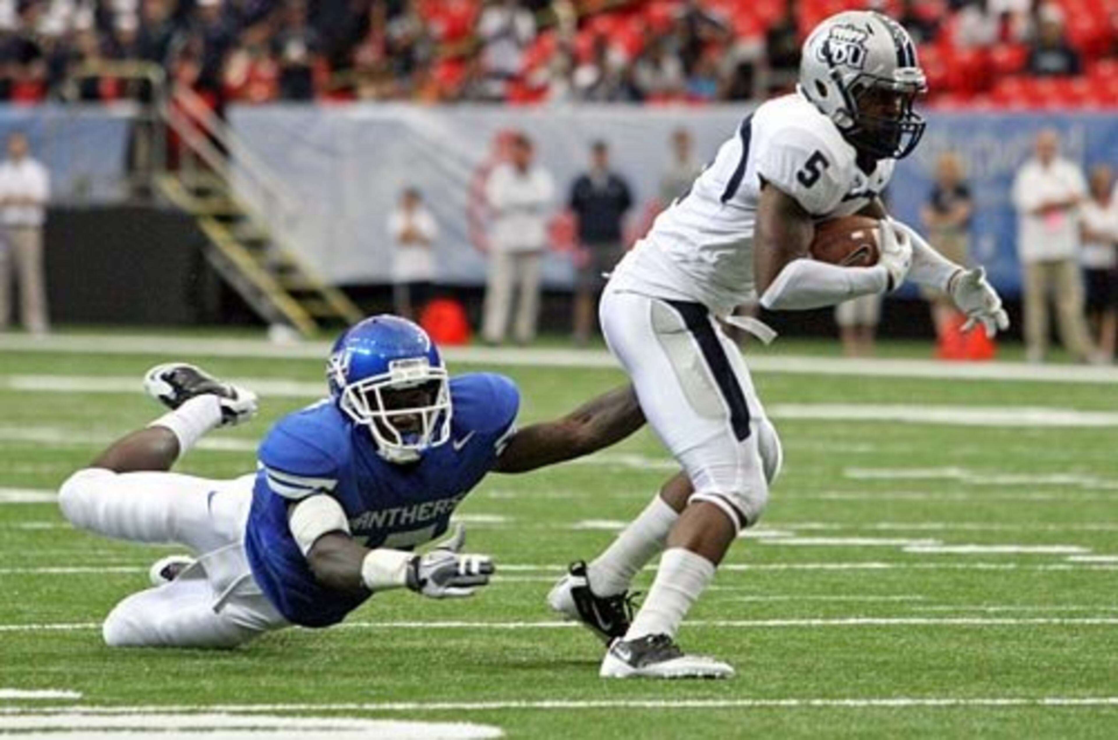 Old Dominion wide receiver Antonio Vaughan (5) gets tackled by GSU linebacker Dexter Moody. Moody was able to hang onto Vaughan and make one of his 10 tackles during the game.