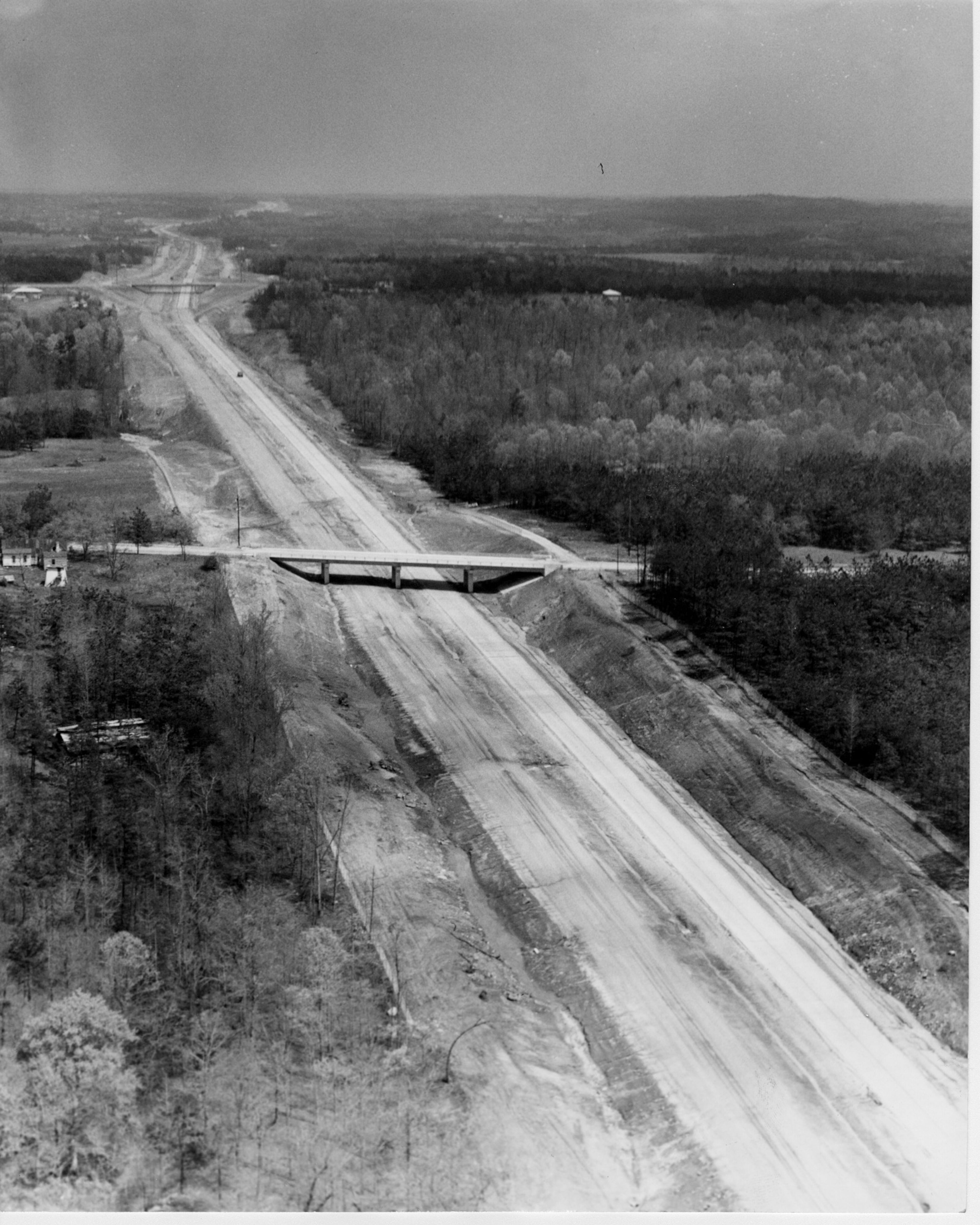 April, 1960 - Atlanta, GA - Aerial views of East Expressway (I-20) construction - Section between Stone Mountain Road and Pole Bridge Creek has outbound lanes paved, others are not. There's paving down from Candler Road to the intersection with U.S. 278 outside Lithonia.
