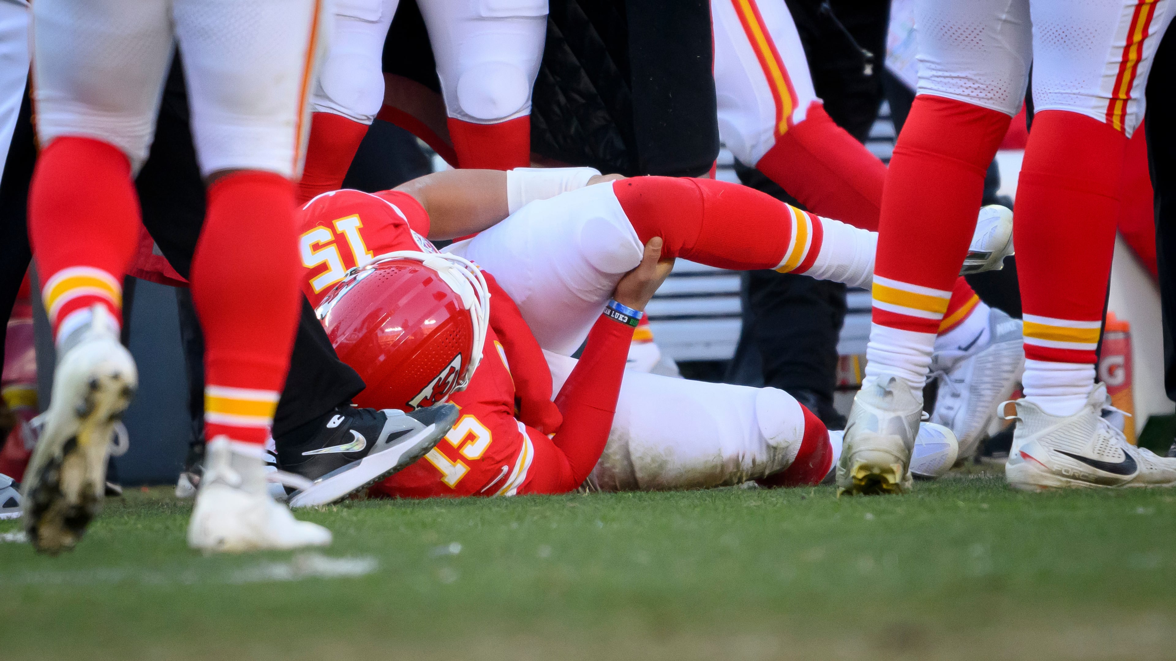 FILE - Kansas City Chiefs quarterback Patrick Mahomes (15) clutches his left knee after being injured during thine second half of an NFL football game against the Los Angeles Chargers, Sunday, Dec. 14, 2025 in Kansas City, Mo. (AP Photo/Reed Hoffmann, File)