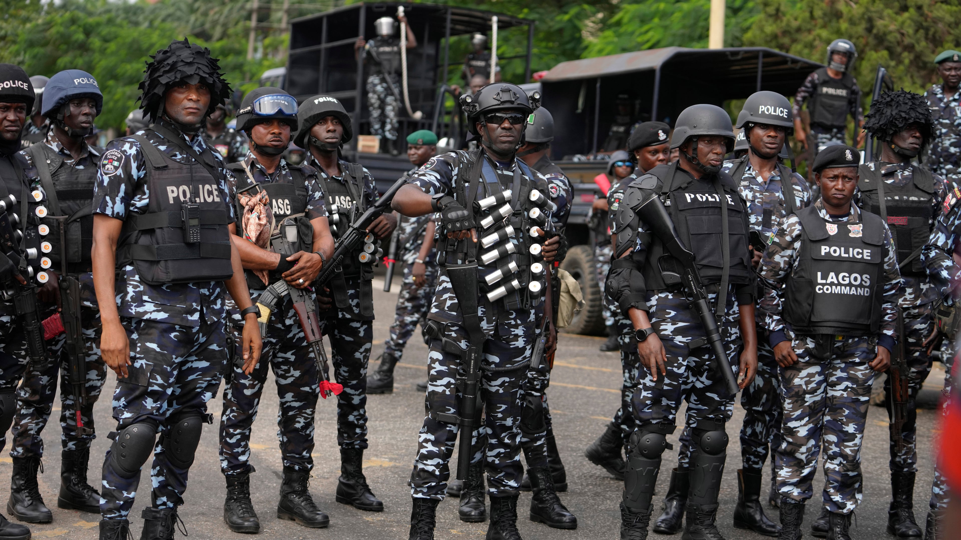 FILE - Nigeria police officers stand guard during a candle light procession in honour of all protesters killed nationwide at the recently economic hardship protest, in Lagos, Nigeria, Friday, Aug. 9, 2024. (AP Photo/Sunday Alamba, file)