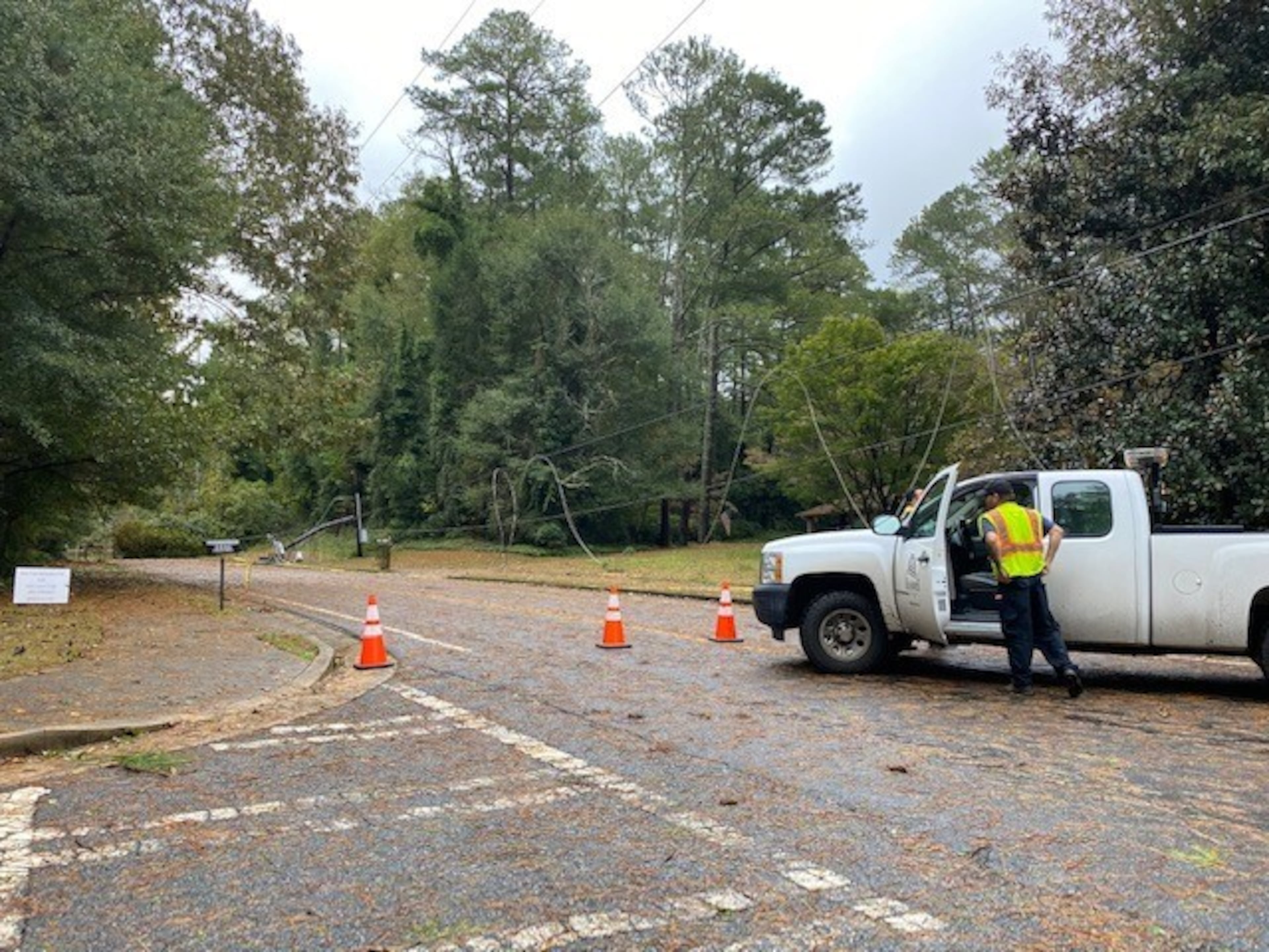 A crew from the city of Roswell stopped traffic on Coleman Road because of downed power lines. (Photo by Todd C. Duncan / AJC)