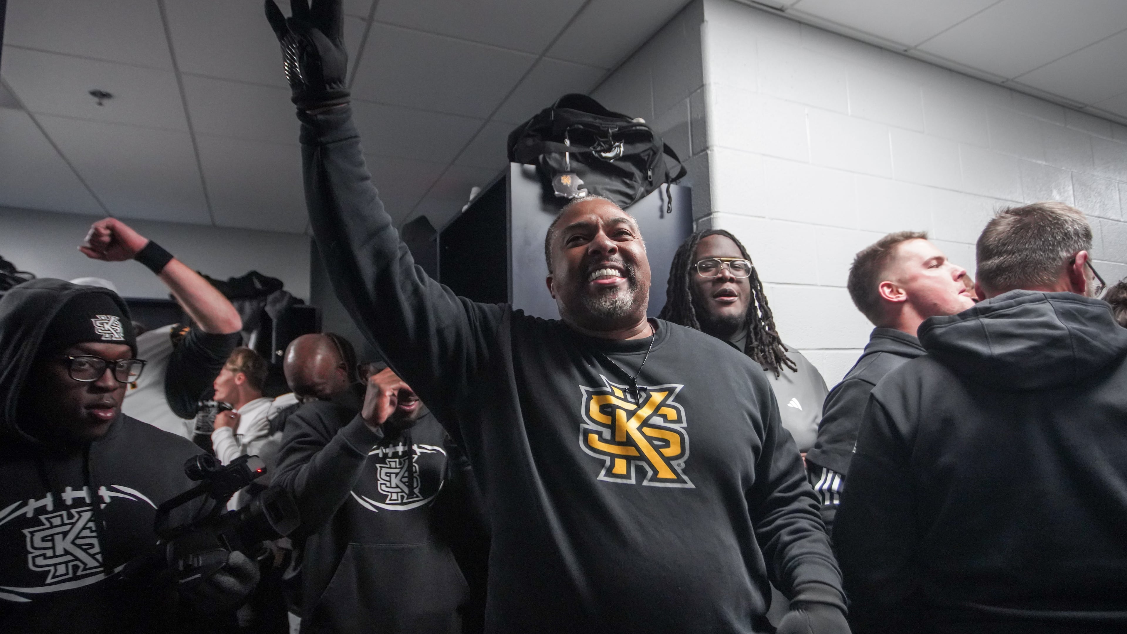 Kennesaw State coach Jerry Mack celebrates in the locker room after the Owls defeated Liberty in overtime to earn a spot in the CUSA championship game. (Courtesy of Kennesaw State Athletics)