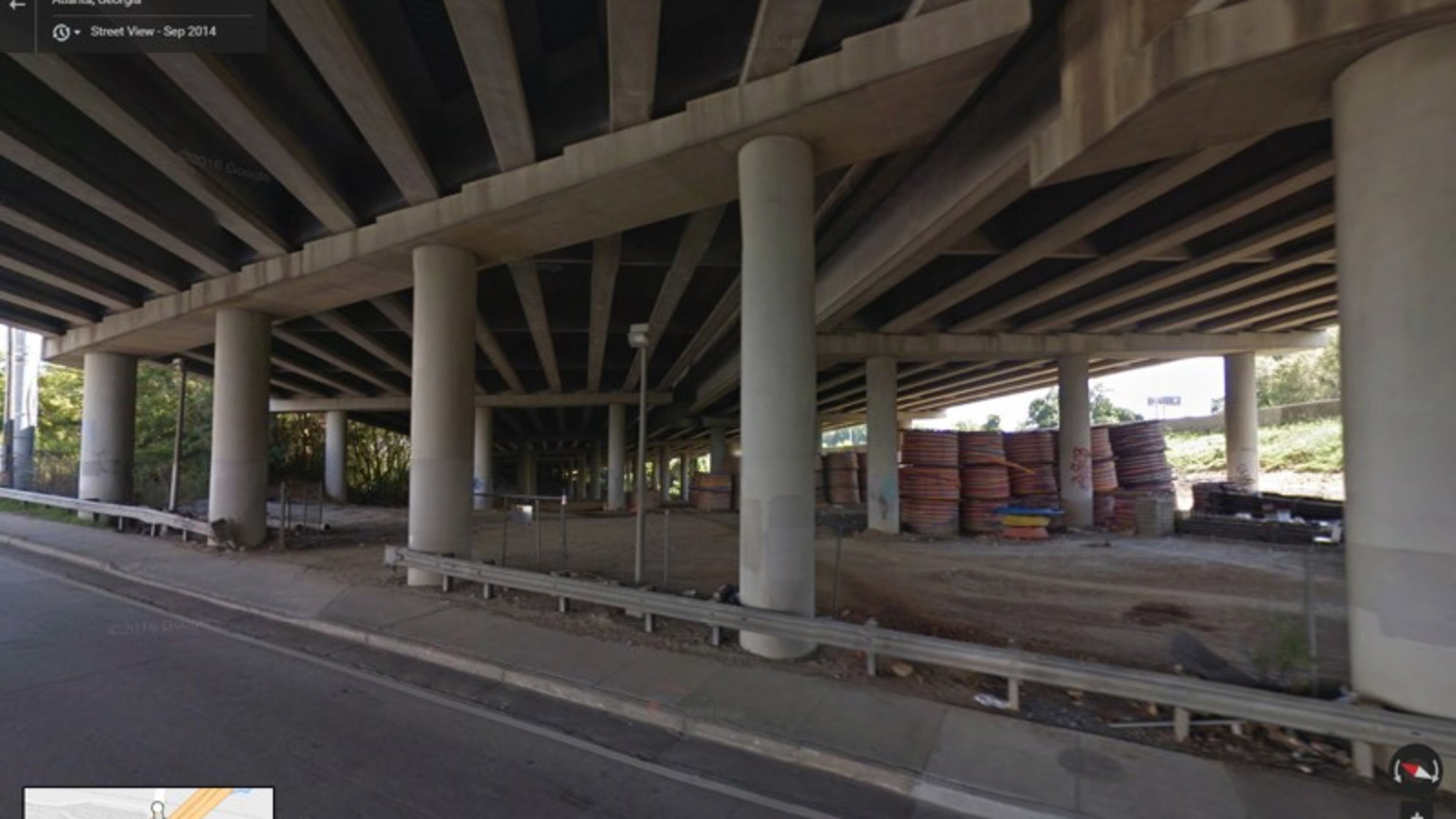 This image from Google Maps Street View shows the spools of high-density polyethylene conduit in September 2014, stored under the portion of I-85 that collapsed last week. The conduit is blamed as causing the fire to burn hot enough to collapse the bridge.