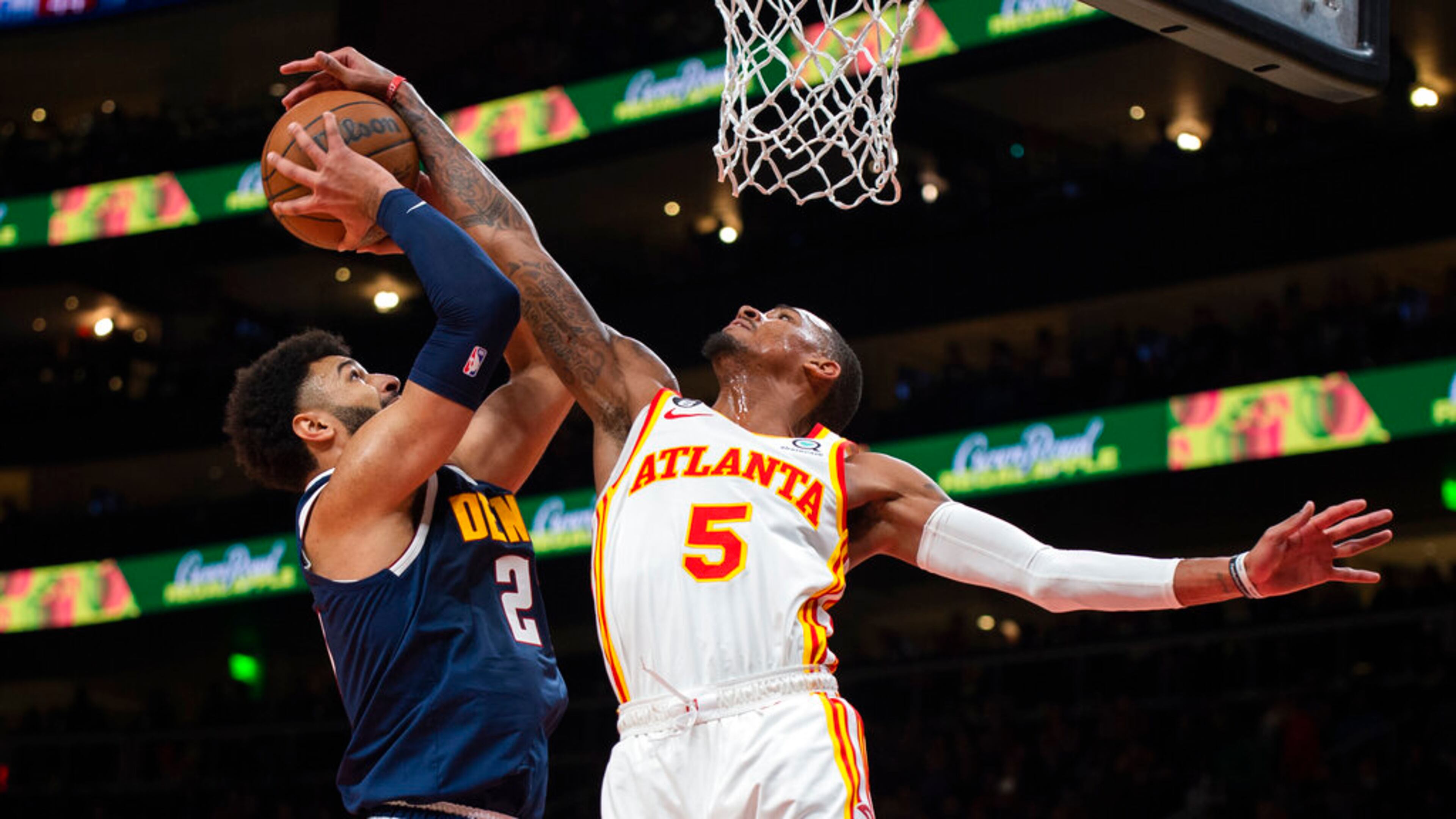 Denver Nuggets guard Jamal Murray, left, has his shot is blocked and is fouled by Atlanta Hawks guard Dejounte Murray (5) during the second half of an NBA basketball game Friday, Dec. 2, 2022, in Atlanta. (AP Photo/Hakim Wright Sr.)