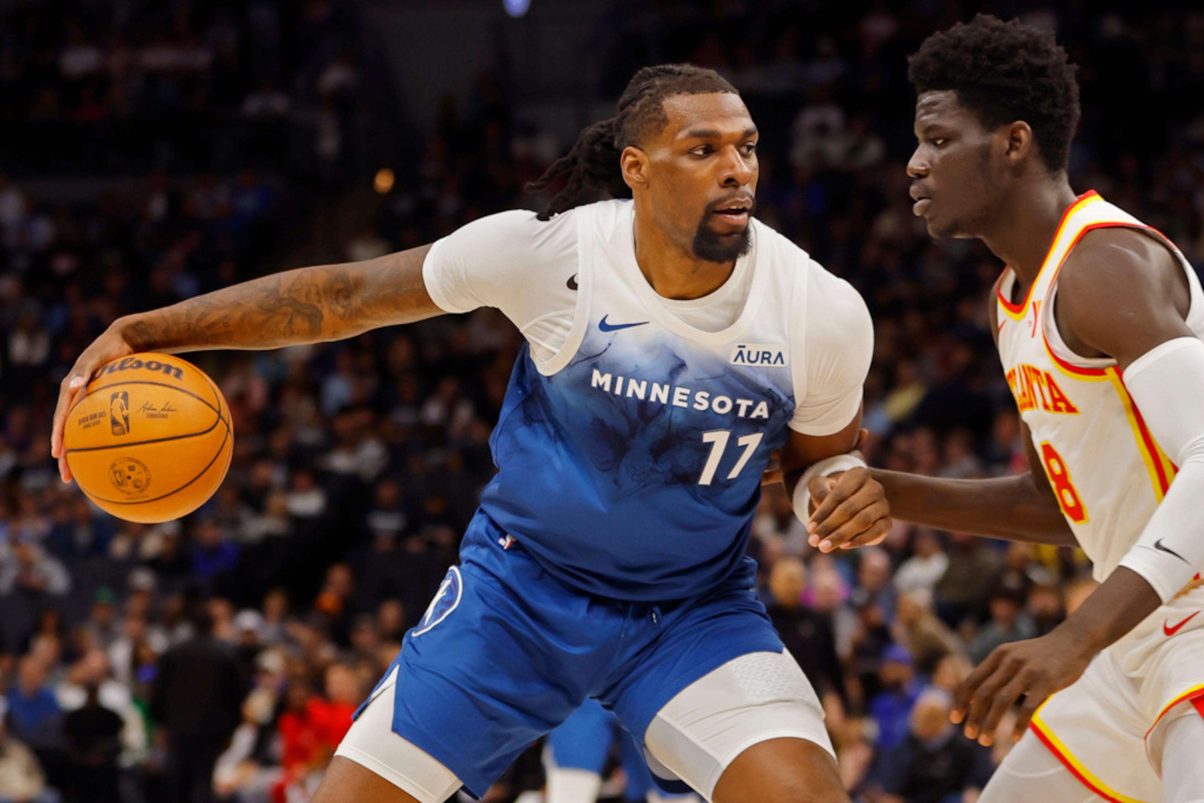 Minnesota Timberwolves center Naz Reid (11) works around Atlanta Hawks forward Mouhamed Gueye during the first quarter of an NBA basketball game Friday, April 12, 2024, in Minneapolis. (AP Photo/Bruce Kluckhohn)