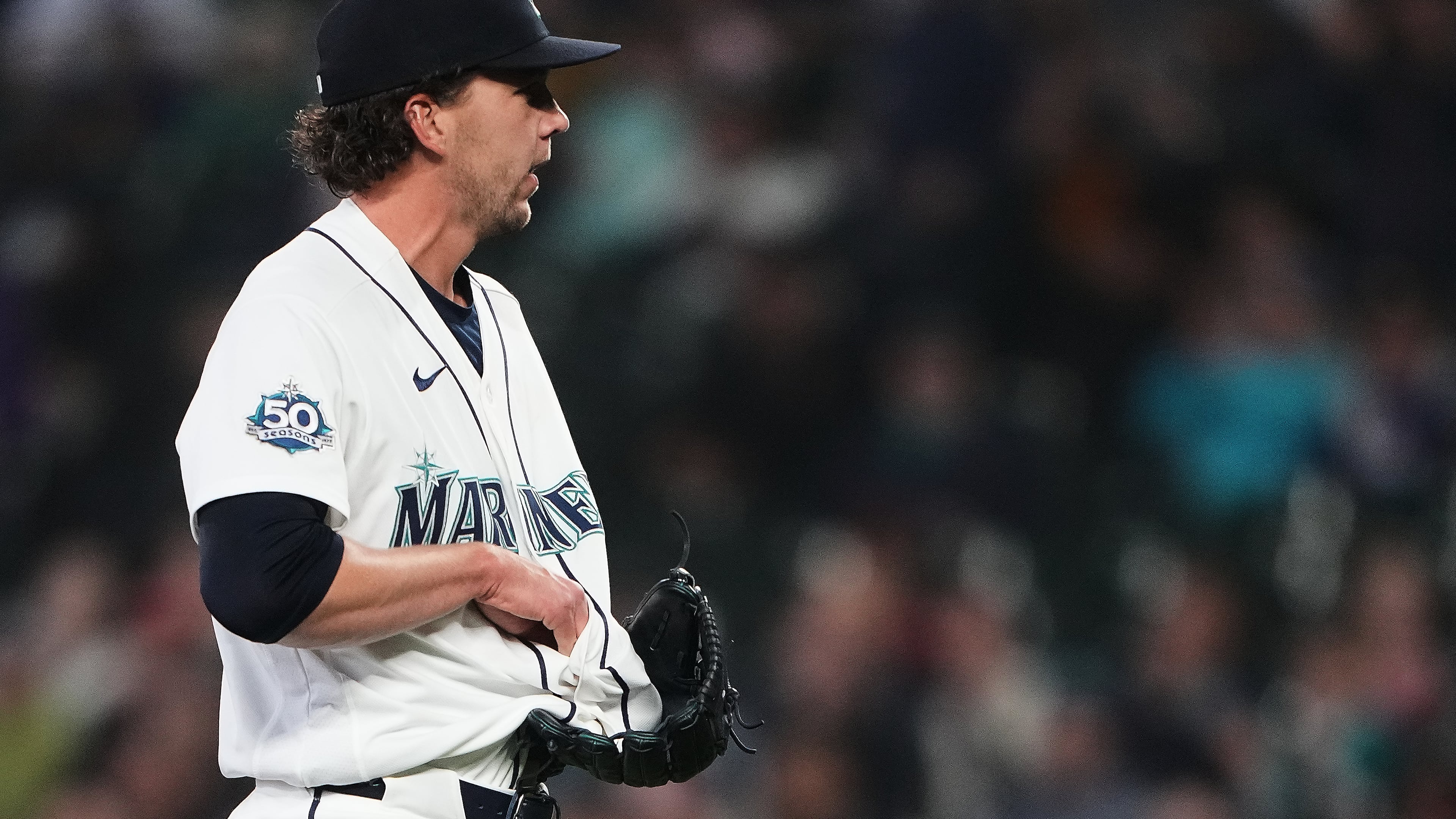 Seattle Mariners starting pitcher Logan Gilbert tries to fish out the ball after Athletics' Carlos Cortes hit a line drive base hit into his jersey during the first inning of a baseball game, Wednesday, April 22, 2026, in Seattle. (AP Photo/Lindsey Wasson)