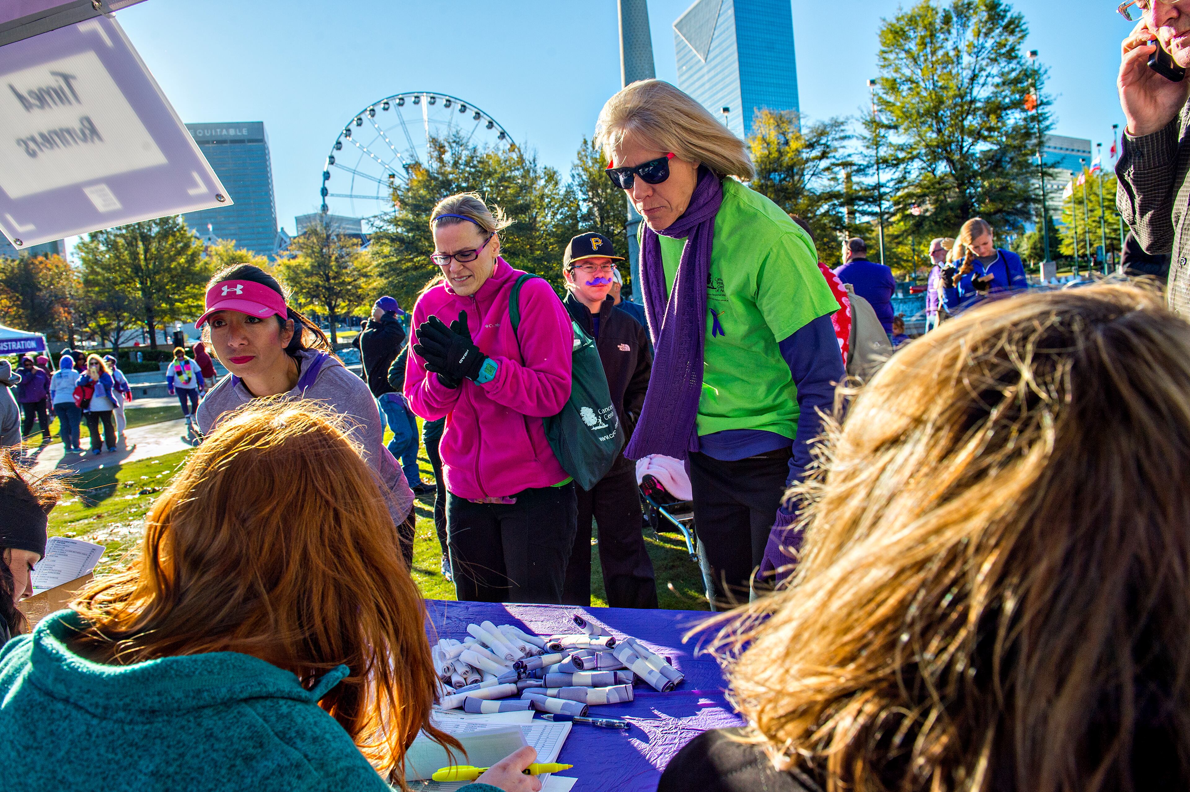 November 14, 2015 Atlanta - Laurie Plath (center) and Kristen Nigro register to walk in the PurpleStride Atlanta 5k at Centennial Olympic Park in Atlanta on Saturday, November 14, 2015. Participants raised over $265,000 for the Pancreatic Cancer Action Network. JONATHAN PHILLIPS / SPECIAL