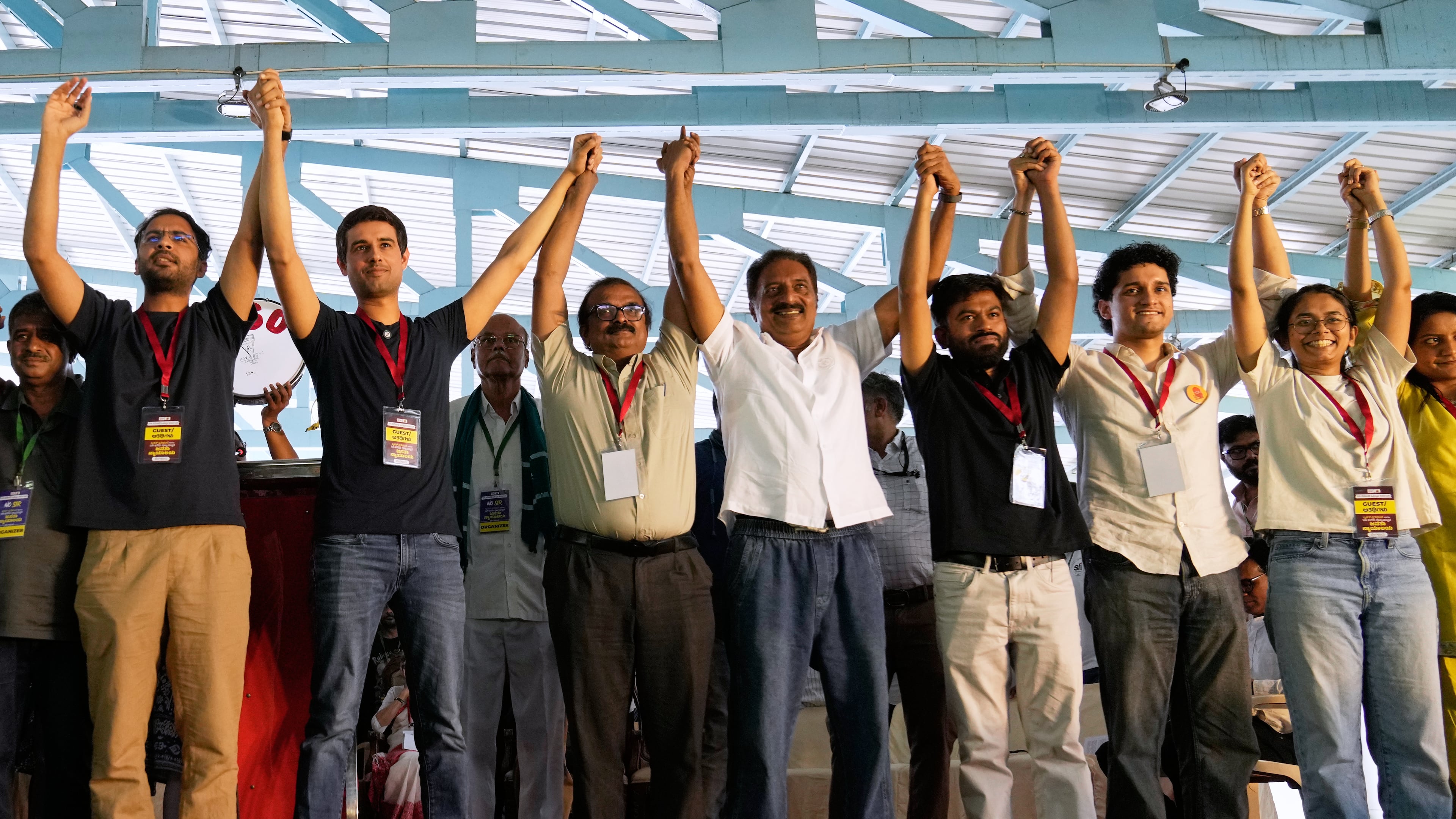 Indian influencer and activist Dhruv Rathee, second left, Indian actor Prakash Raj, fourth left, Cockroach Janta Party founder Abhijeet Dipke, fifth left and other supporters join hands during a protest demanding the resignation of the country's election chief Gyanesh Kumar, in Bengaluru, India, Thursday, Oct. 8, 2026. (AP Photo/Aijaz Rahi)