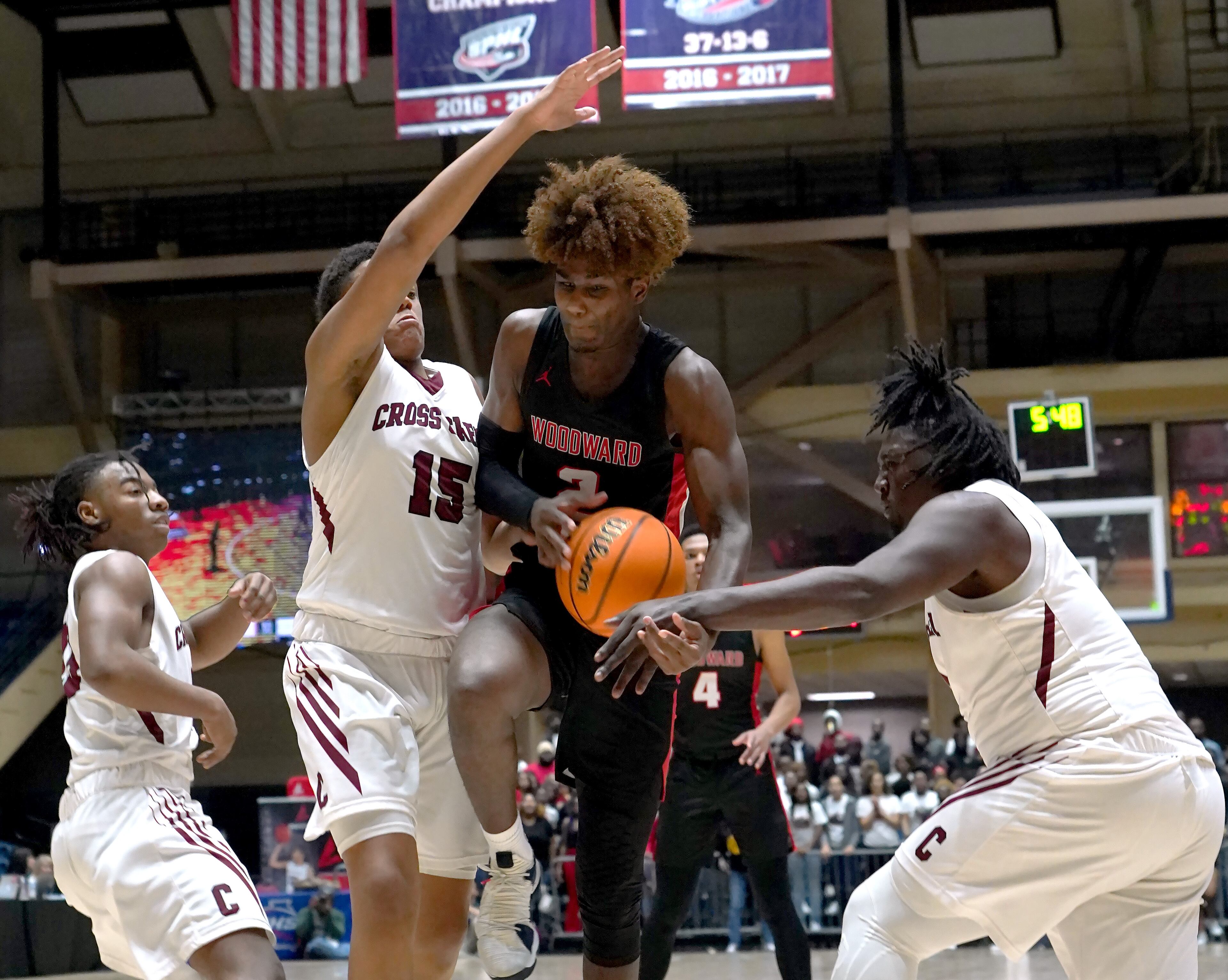 Woodward Academy's Emory Lanier (2) battles for a loose ball with Cross Creek's Corey Trotter (15)and Markell Ware in the second half of the Class AAAA boys title basketball game at the Macon Centreplex, Friday March 6, 2020, in Macon. Tami Chappell for the Atlanta Journal Constitution