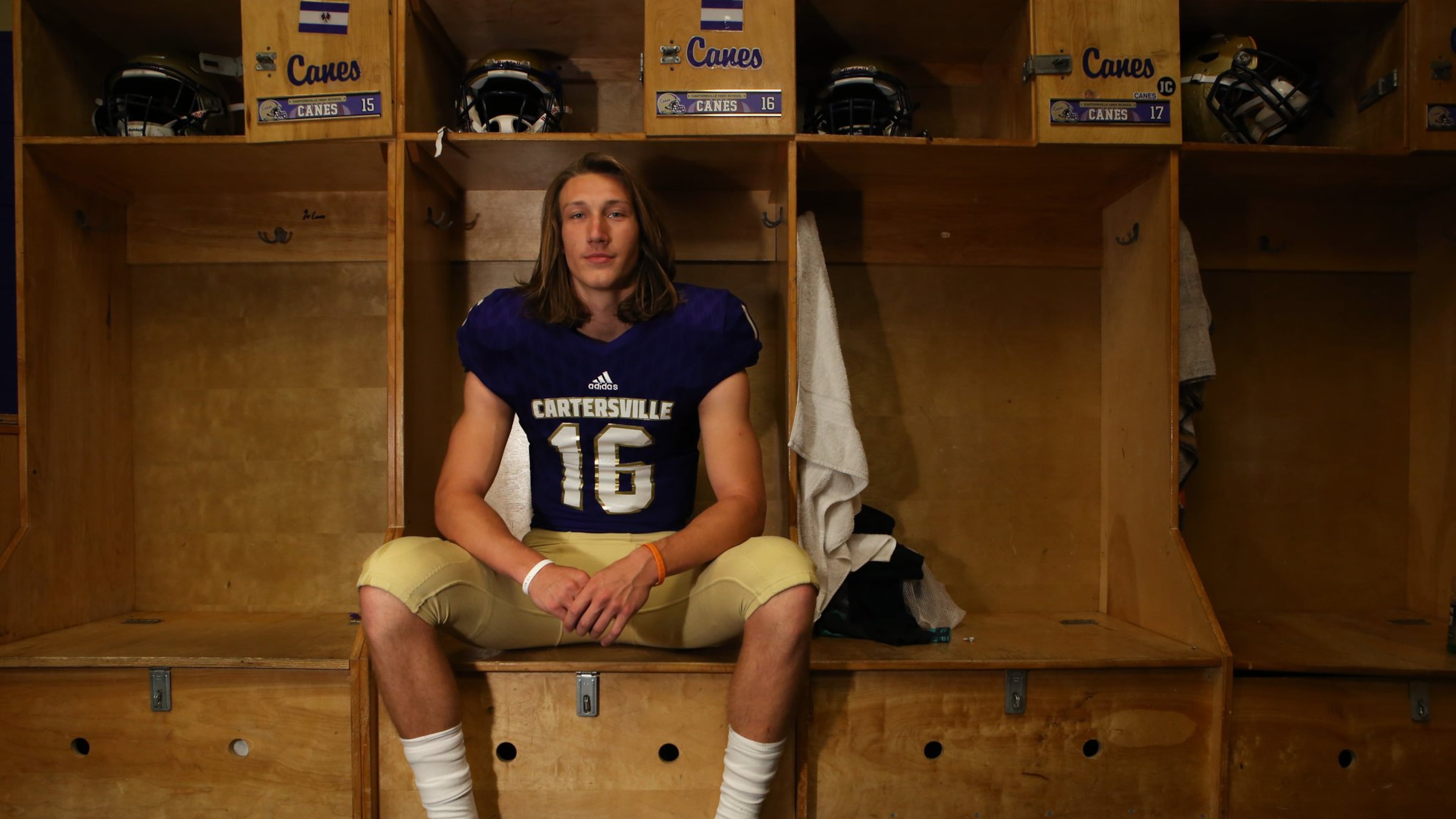 Trevor Lawrence, 17, a rising senior at Cartersville High School, poses for a portrait brandishing his school’s new football uniform in the football locker rooms of CHS on May 5, 2017. Lawrence led his team to win the state championship for Class AAAA. He committed to Clemson and will graduate from Cartersville High in 2018. (HENRY TAYLOR / HENRY.TAYLOR@AJC.COM)