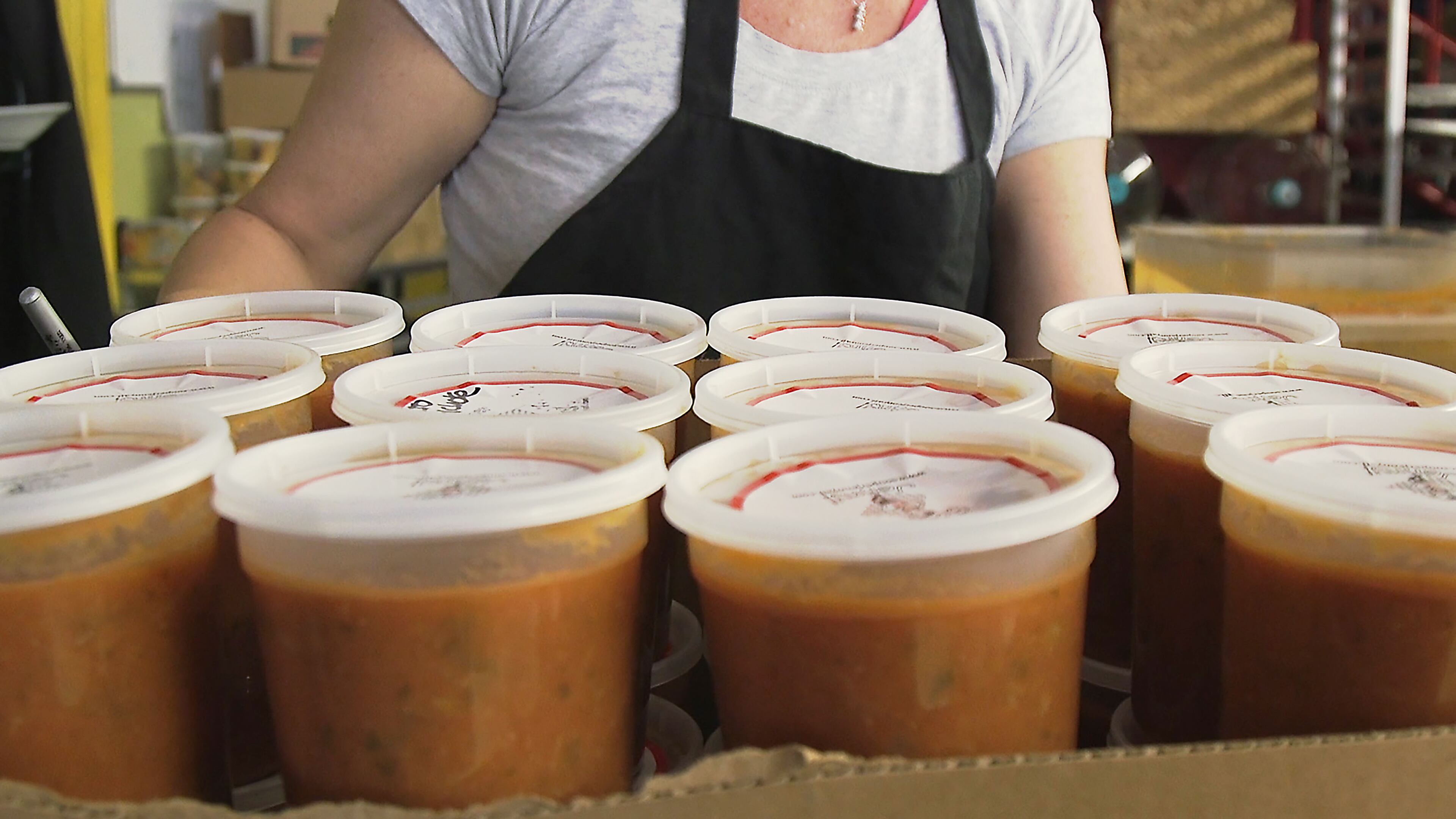 November 30, 2018 Atlanta - Amanda Marmins, a volunteer at Souper Jenny, finishes the preparation for one box of soup that will help feed kids in the metro area. RYON HORNE / RHORNE@AJC.COM