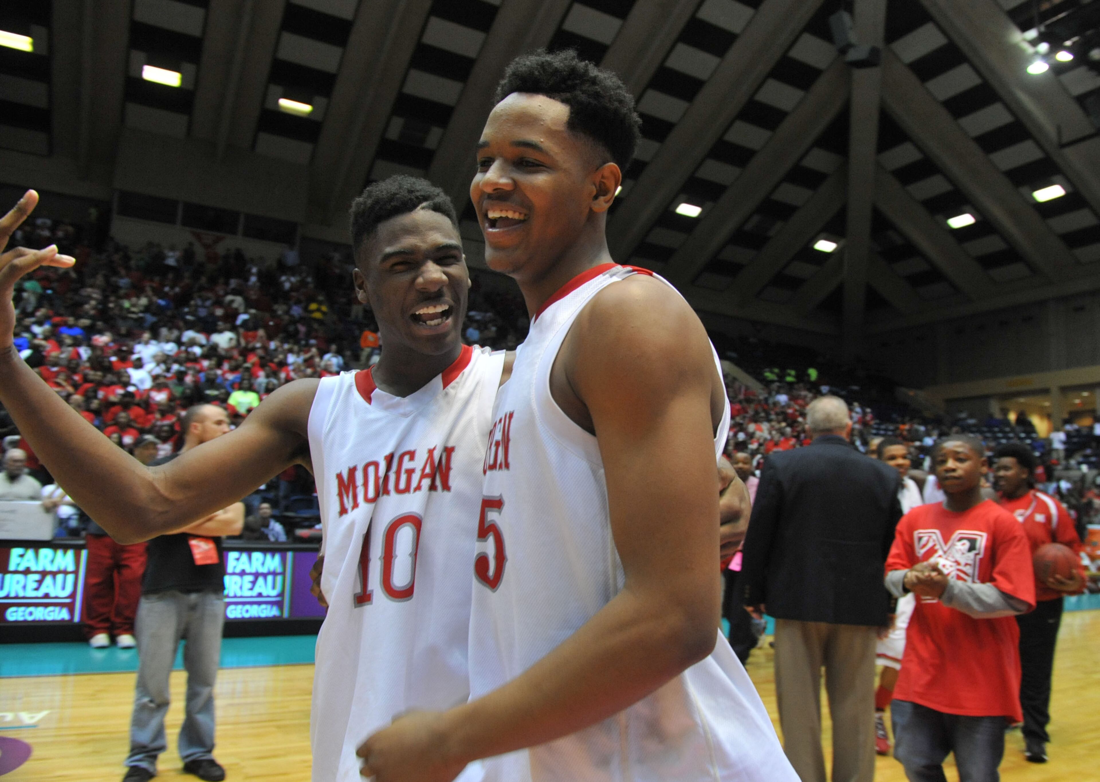 Morgan County Bulldogs Devorious Brown #10 and Jailyn Ingram #15 celebrate after the game. Coverage of the Class AAA boys basketball championship between the Buford Wolves and Morgan County Bulldogs at the Macon Coliseum Saturday, March 8, 2014. Morgan County won handily, beating the Buford Wolves 69-45.