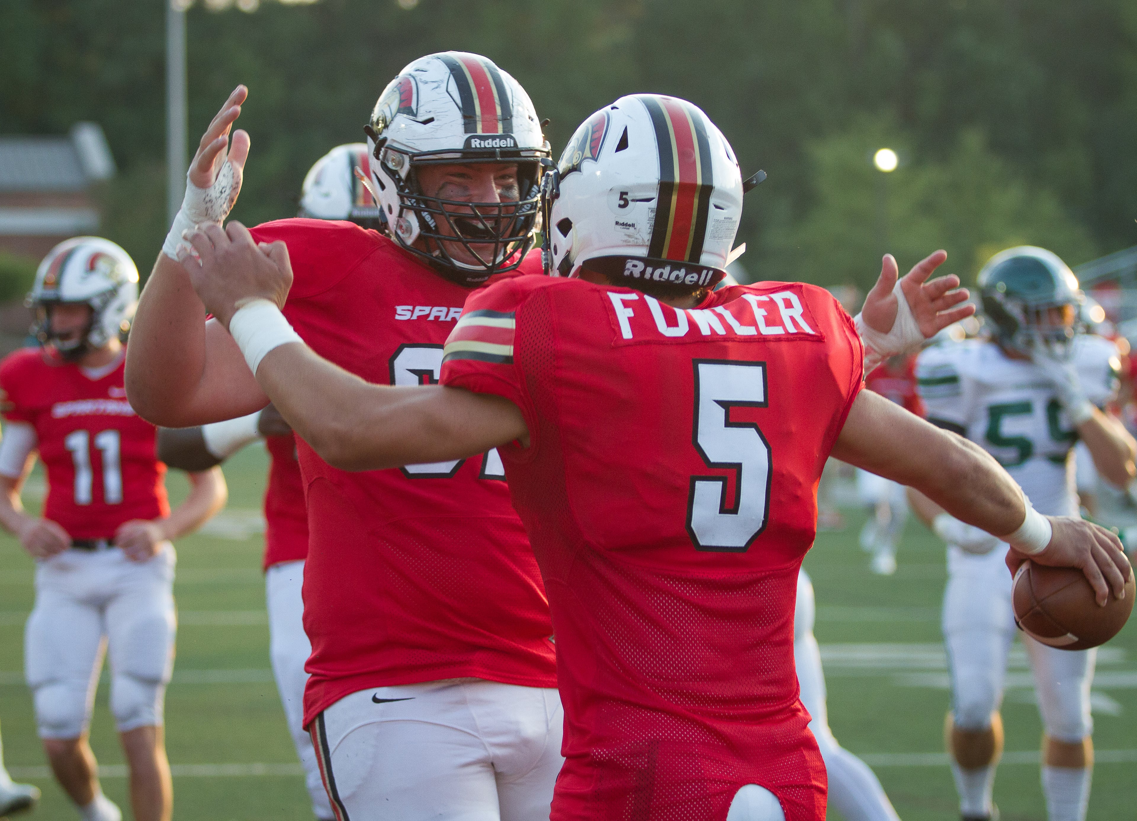 Greater Atlanta Christian School's Nate Richey (67) and Robby Flowers (5) celebrate in the end zone after Flowers scored a touchdown during the first quarter of their game with Westminster in Norcross Ga Friday, August 25, 2017. Greater Atlanta Christian School beat Westminster 41 to 7. STEVE SCHAEFER / SPECIAL TO THE AJC