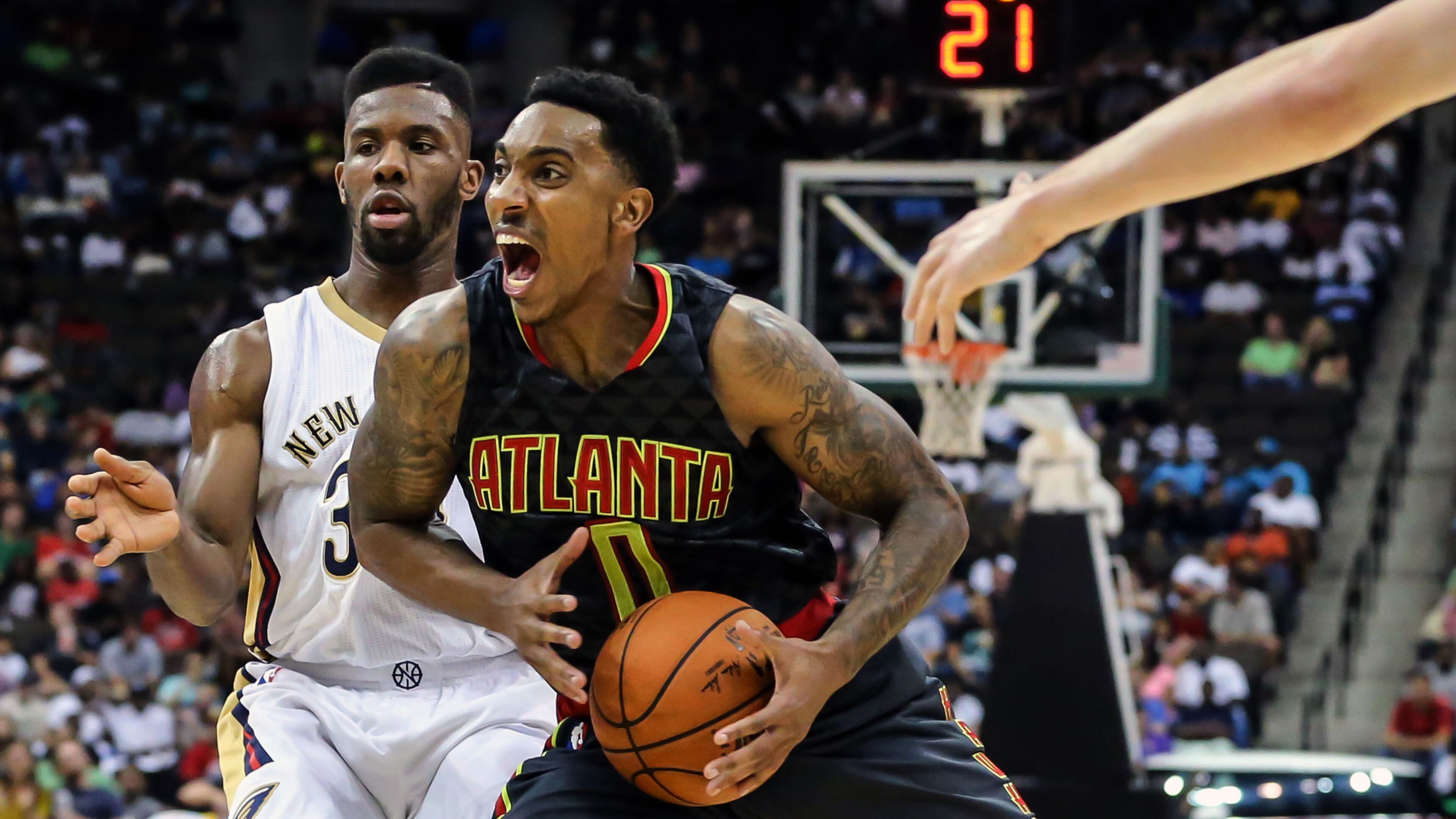 Atlanta Hawks guard Jeff Teague (0) drives to the basket in front of New Orleans Pelicans guard Norris Cole (30) during the first half of an NBA preseason basketball game in Jacksonville, Fla., Friday, Oct. 9, 2015. (AP Photo/Gary McCullough)