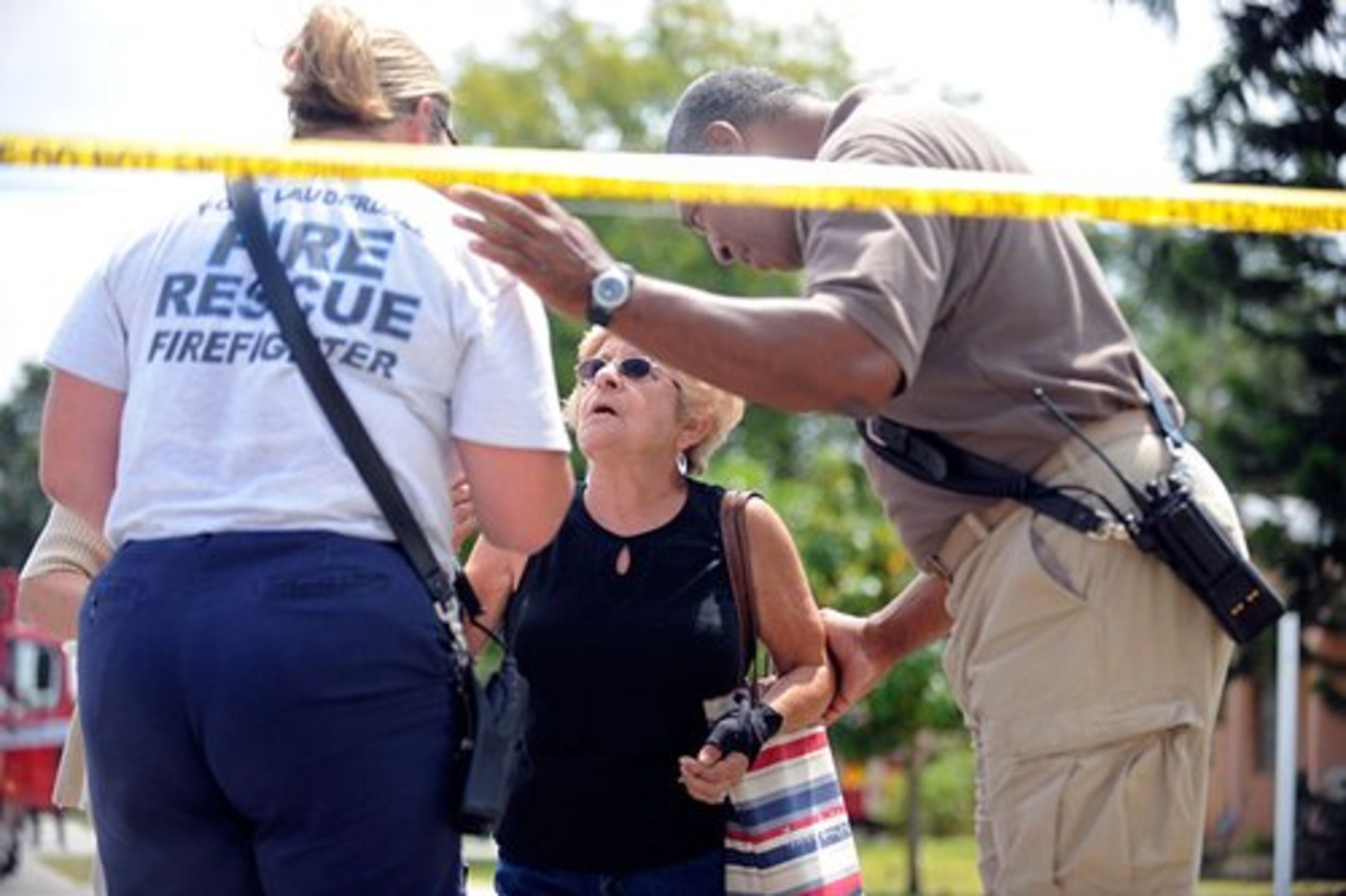 Police and fire officials direct residents away from the scene.