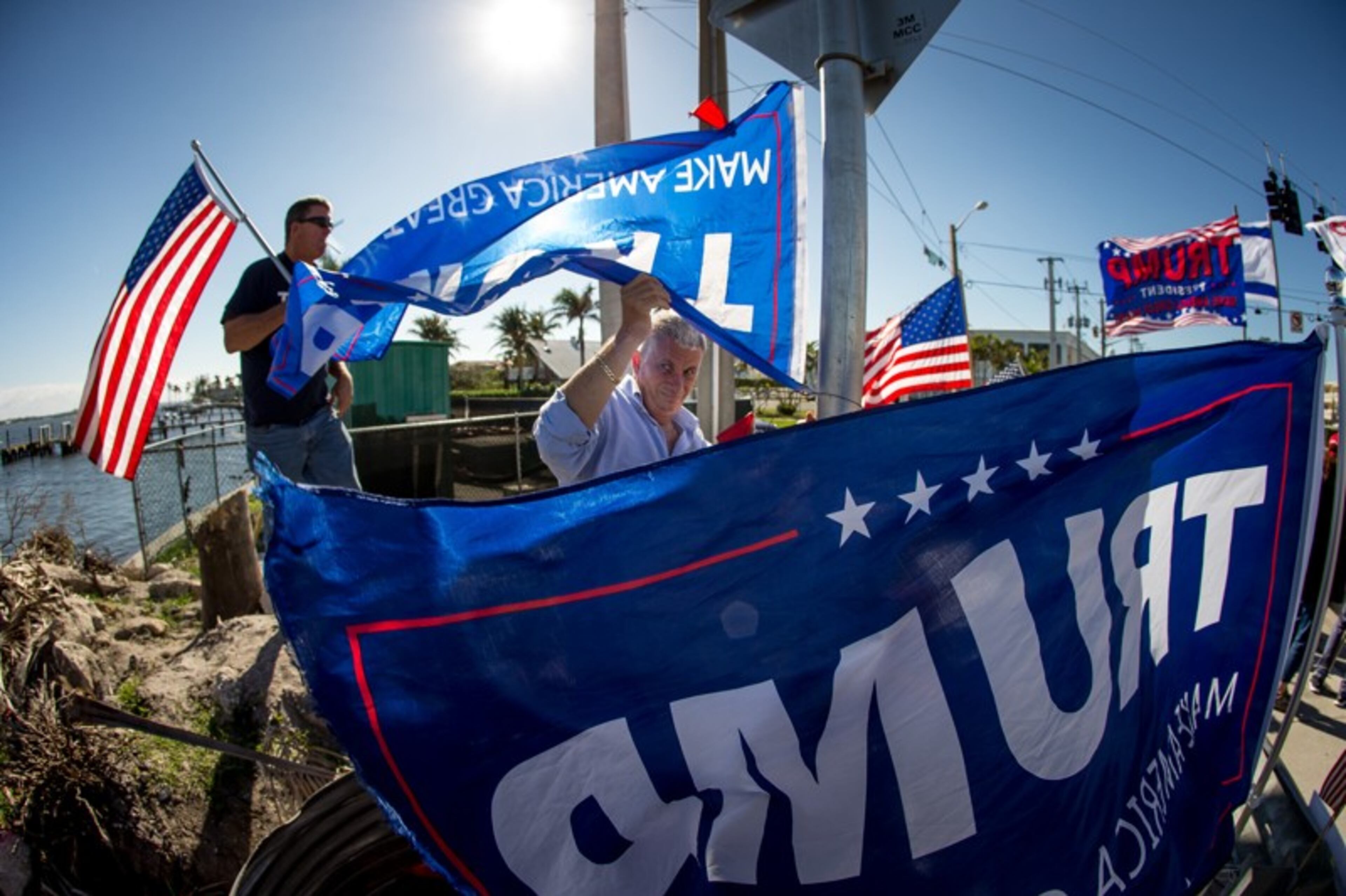 Boynton Beach resident Donald Tarca Jr. sets up Trump banners at the intersection of Southern Blvd. and Flagler Dr. while waiting for President Donald Trump's motorcade to pass by on the the way to Mar-A-Lago December 31, 2017. Tarca and about 15 or so supporters came out to wave at the President each day during his Christmas vacation in Palm Beach, and on December 30 the President sent vans to pick them up and bring them to Mar-A-Lago for a visit. (Photo: Damon Higgins / The Palm Beach Post)