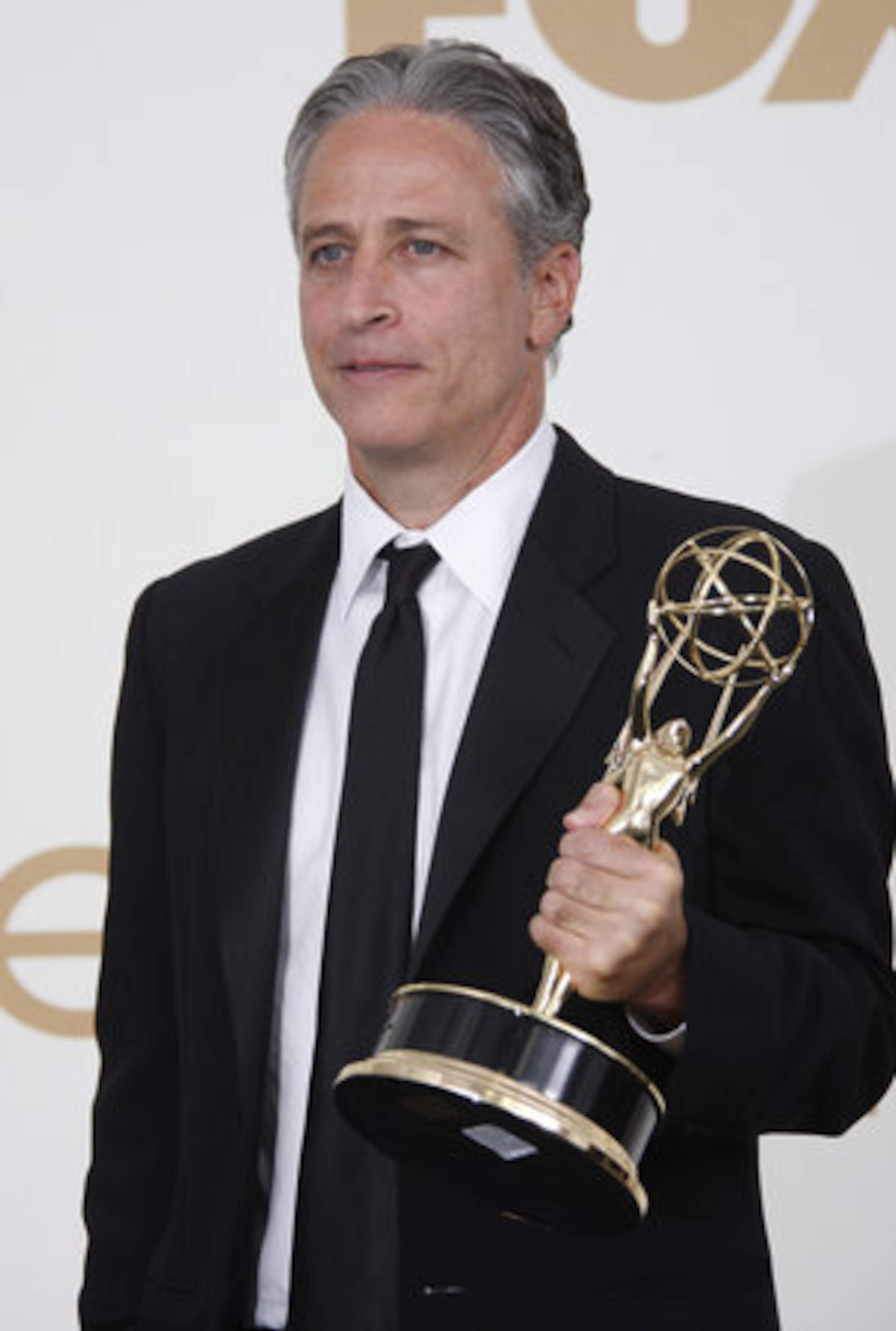 Jon Stewart poses with his award.