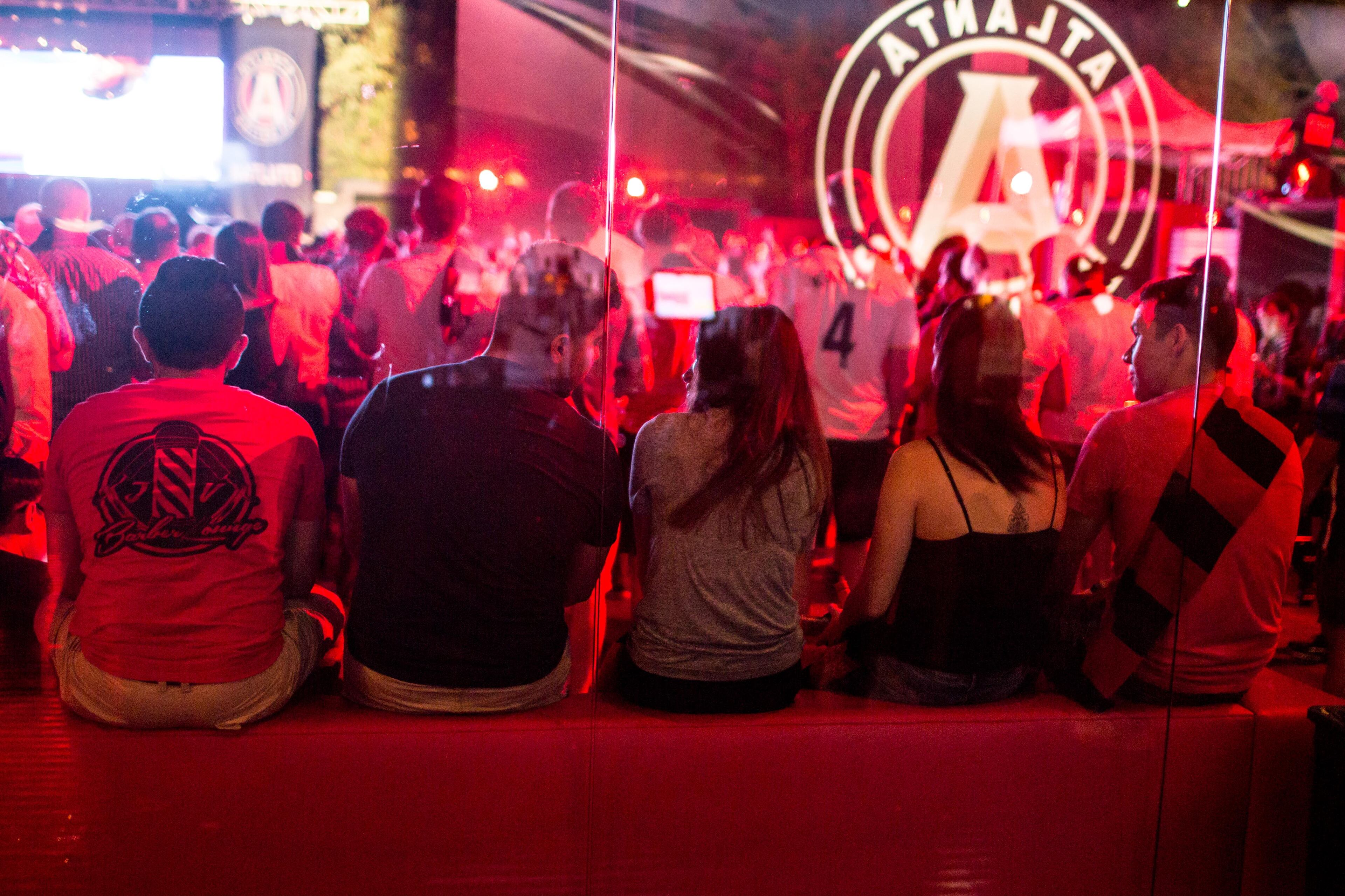 Fans watch a soccer game during a party at which Atlanta United FC was announced as the name of an MLS soccer expansion team, Tuesday, July 7, 2015, in Atlanta. The team is scheduled to begin to play in 2017 at the city's new retractable -oof stadium.(AP Photo/Branden Camp)