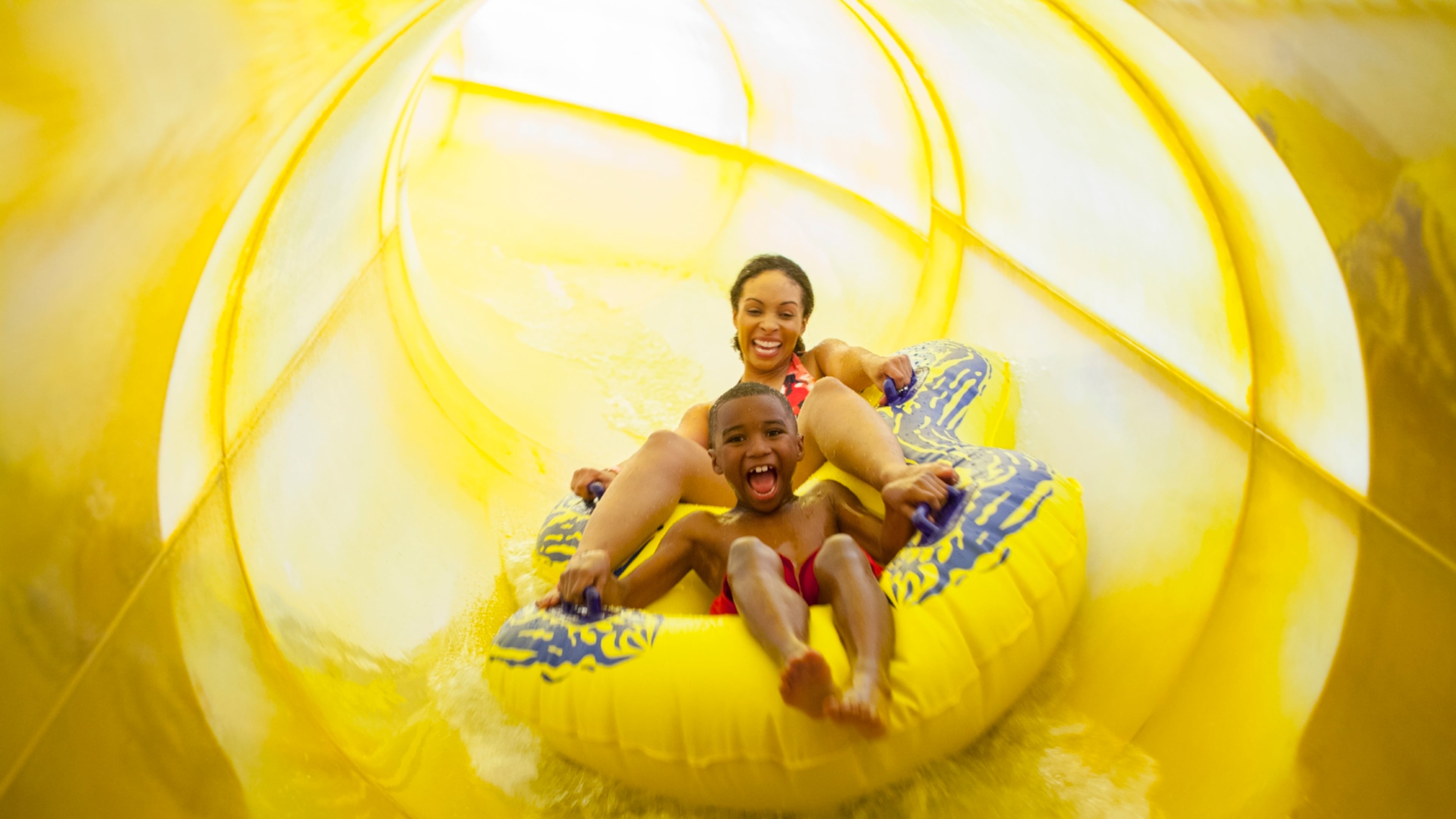 Bubbly fun: A mom and son hold on while enjoying a slide at Great Wolf Lodge.
(Courtesy of Great Wolf Lodge)