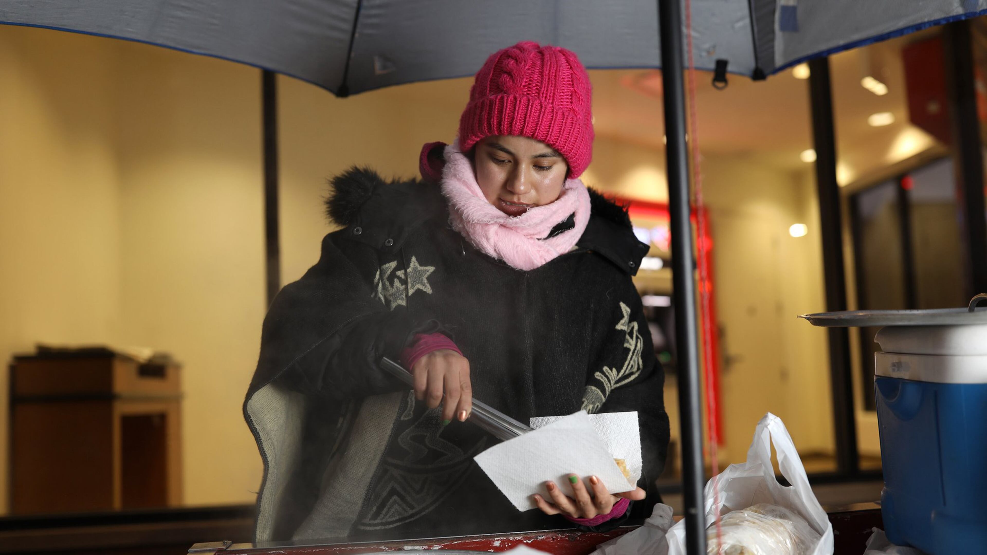 Elizeth Arguelles, 23, serves a customer tamales in Chicago’s Little Village neighborhood. She is studying International Business at Dominican University. ABEL URIBE/CHICAGO TRIBUNE/TNS