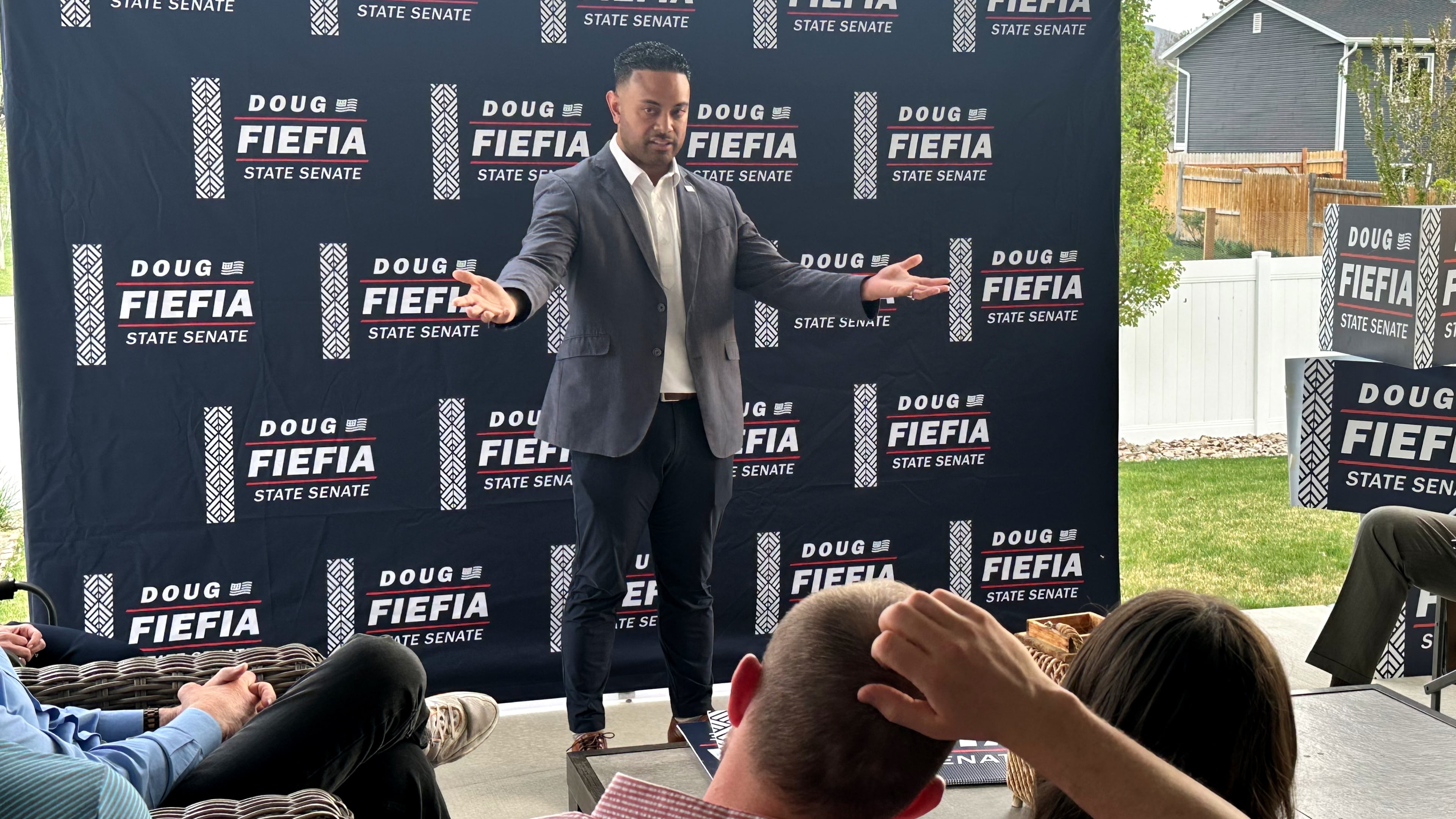 Utah State Rep. Doug Fiefia talks to Utah voters on the back deck of a house, Thursday, April 9, 2026, in Riverton, Utah. Fiefia, a Republican, has a background in technology and is running for the state senate with a pledge to tackle AI. (AP Photo/Nicholas Riccardi)