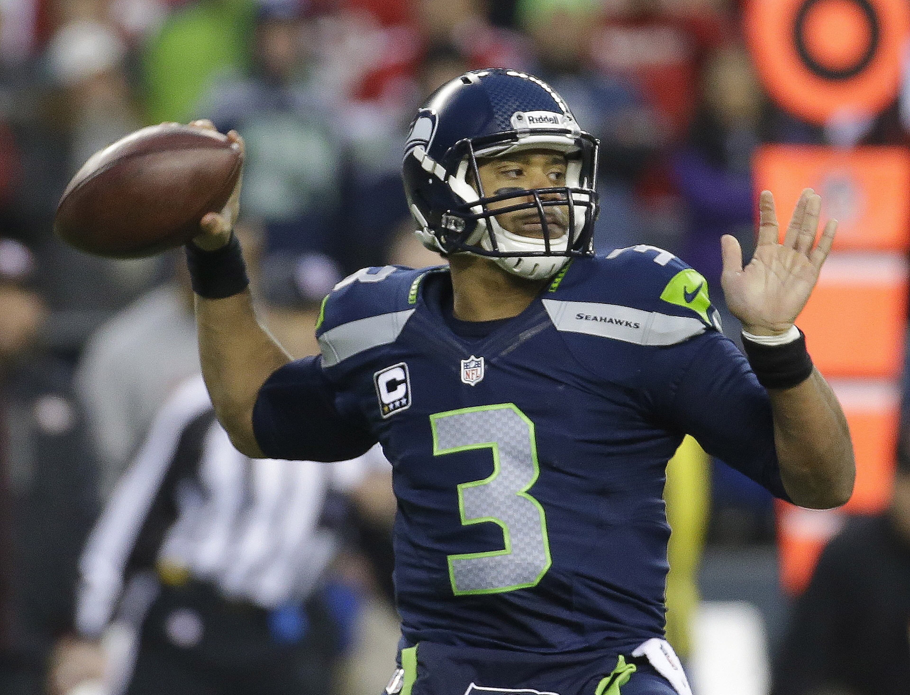 Seattle Seahawks' Russell Wilson throws during the first half of the NFL football NFC Championship game against the San Francisco 49ers, Sunday, Jan. 19, 2014, in Seattle. (AP Photo/Ted S. Warren)
