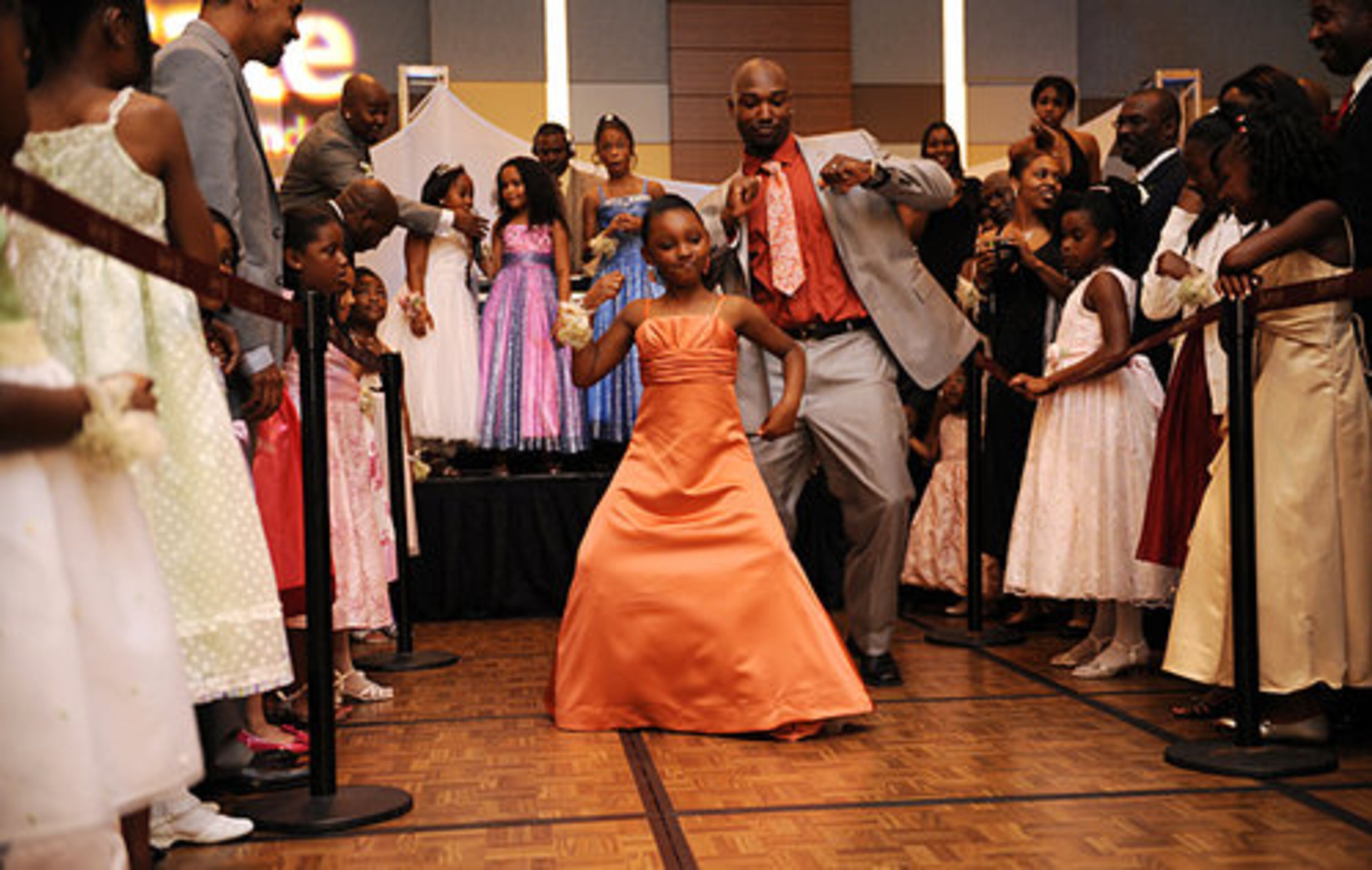 (From left) R'Nyce Barber, 8, and her father Renee Barber, 30, both from Austell, dance down a "daddy daughter 'Soul Train' dance line." "I told her, whatever you do, I'll follow, " Barber says of their dance moves.