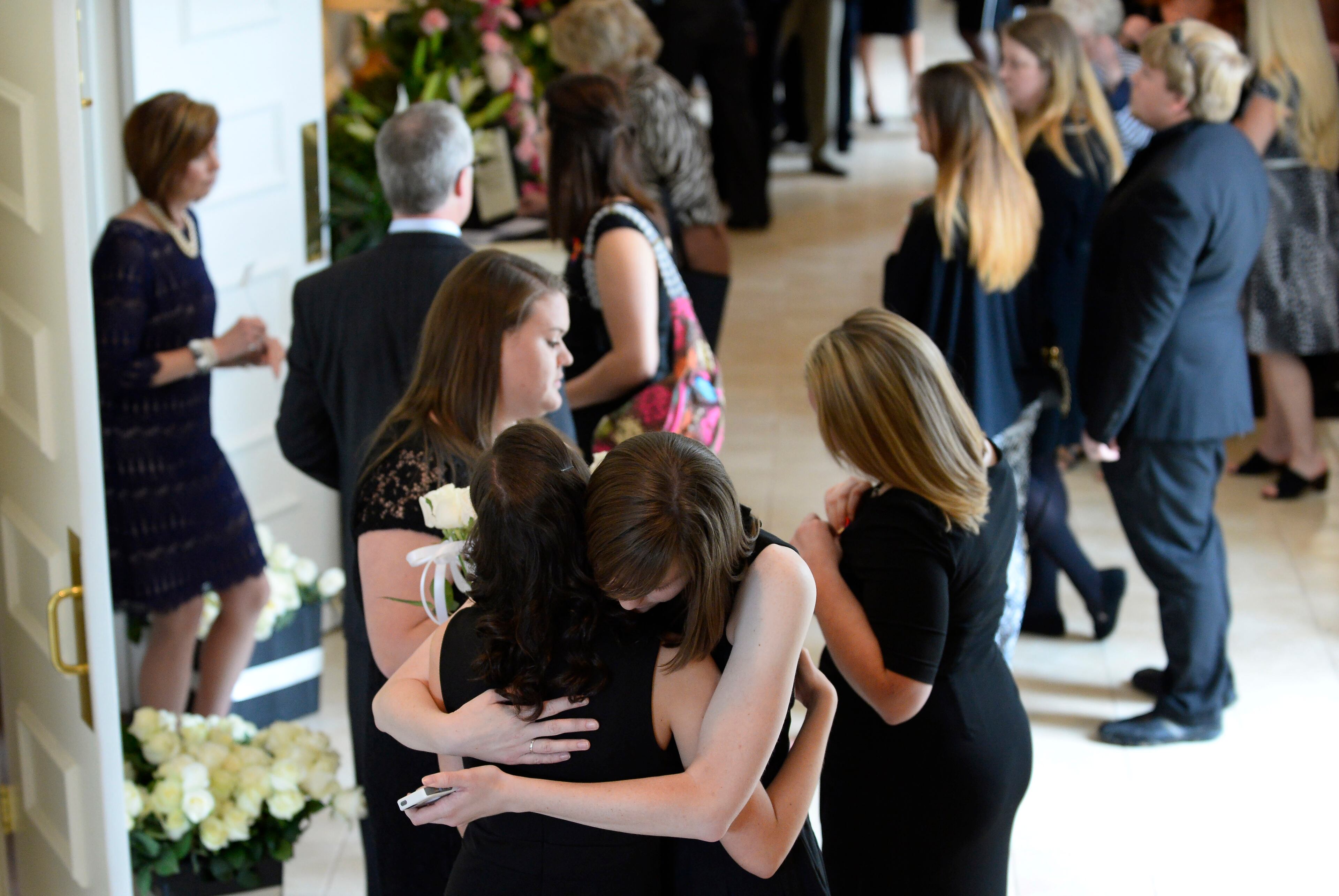 Mourners hug at a celebration of life for Catherine "McKay" Pittman, 21, one of five Georgia Southern University nursing students who were killed in an I-16 highway crash earlier in the week, during services at the First Baptist Church of Alpharetta on Saturday, April 25, 2015, in Alpharetta, Ga. David Tulis / AJC Special