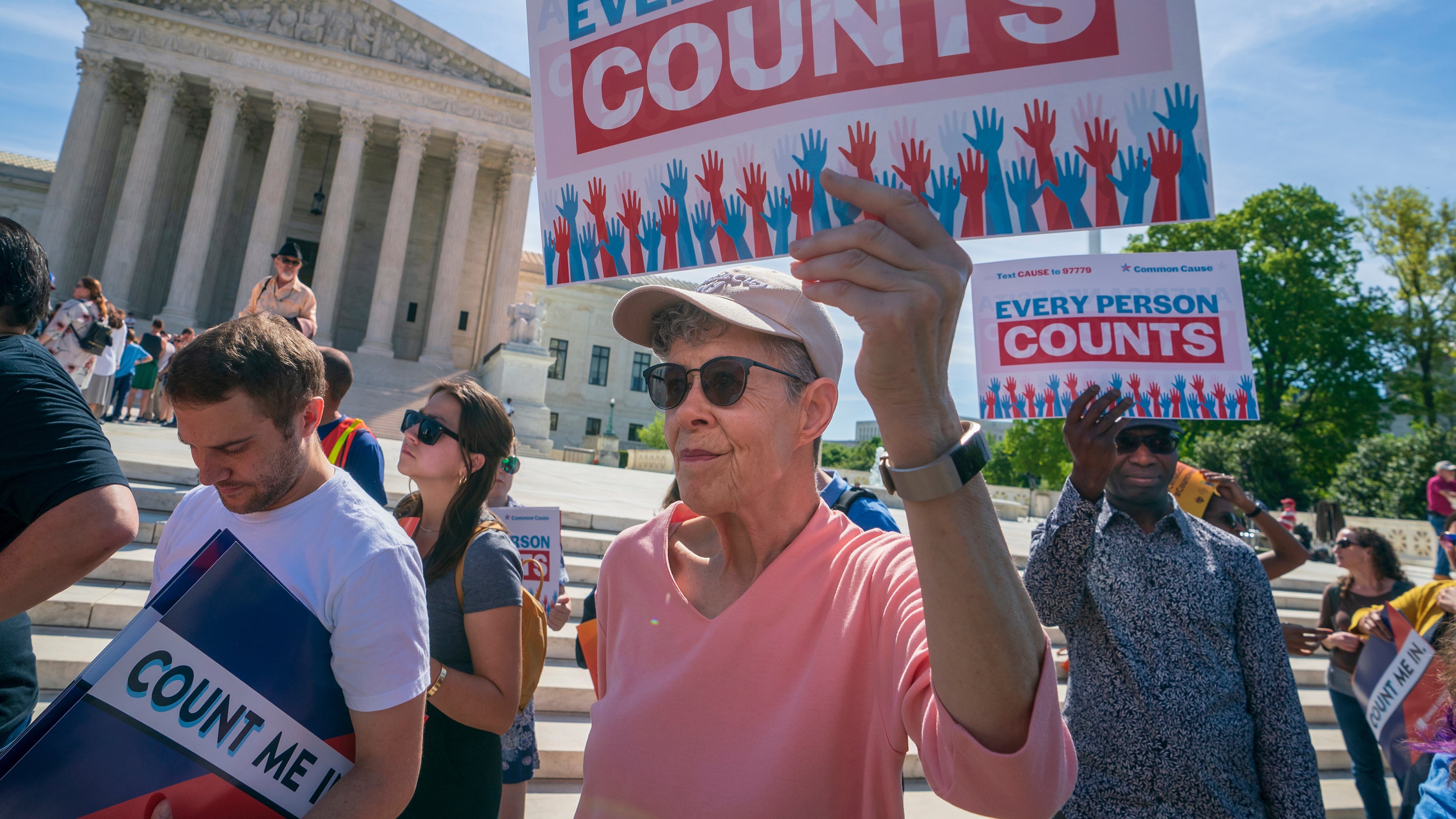 FILE - Immigration activists rally outside the Supreme Court as the justices hear arguments over the Trump administration's plan to ask about citizenship on the 2020 census in Washington, April 23, 2019. (AP Photo/J. Scott Applewhite, File)