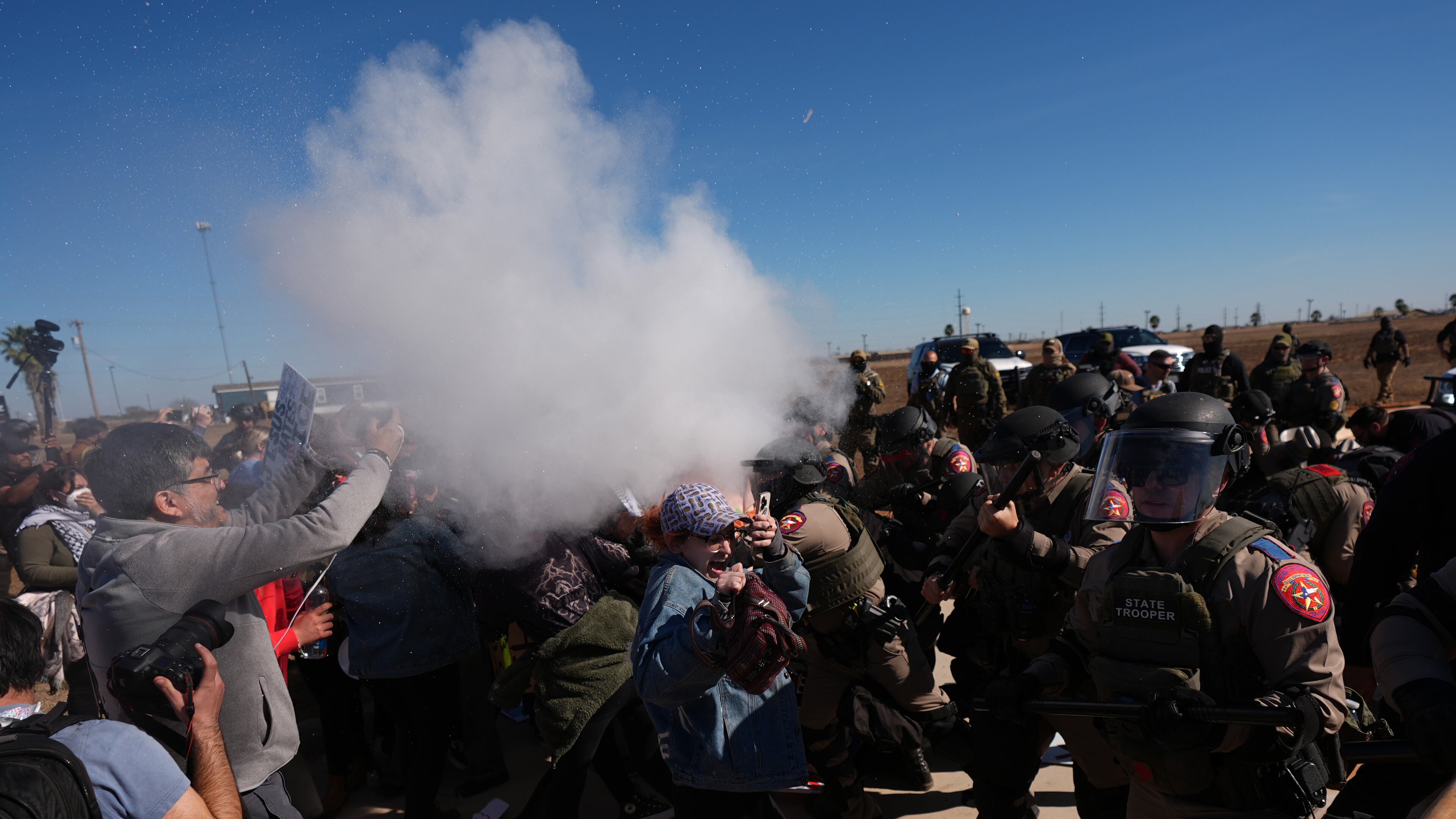 Pepper spray is dispersed towards protesters outside the South Texas Family Residential Center detention facility where Liam Ramos and his father are being detained in Dilley, Texas, Wednesday, Jan. 28, 2026. (AP Photo/Eric Gay)