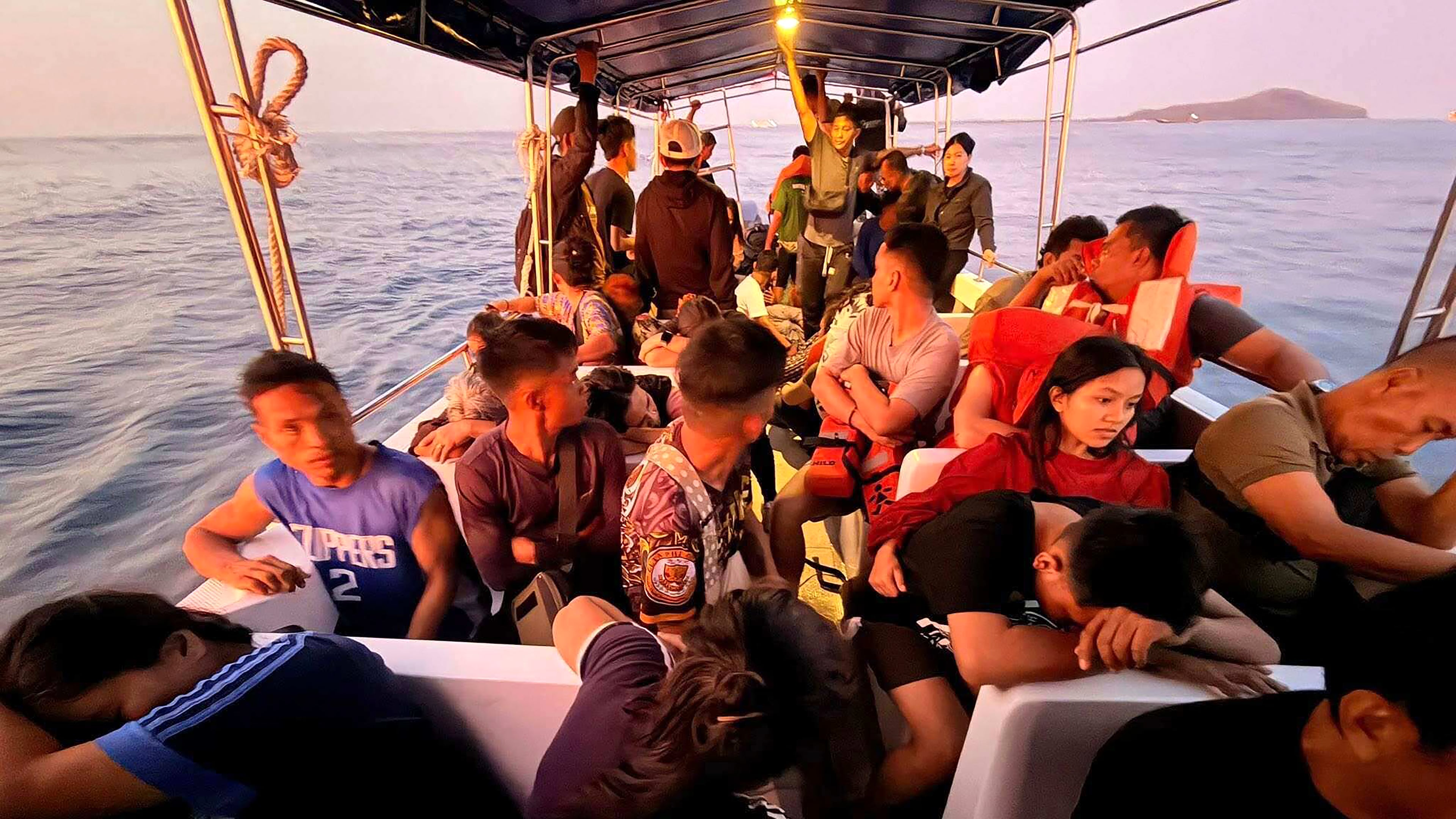 Rescued passengers from M/V Trisha Kerstin, 3 an inter-island cargo and passenger ferry that sank, on a boat around waters of Isabela City, Basilan Province, Philippines on Monday, Jan. 26, 2026. (Kagawad Gamar "Gams" Alih via AP)