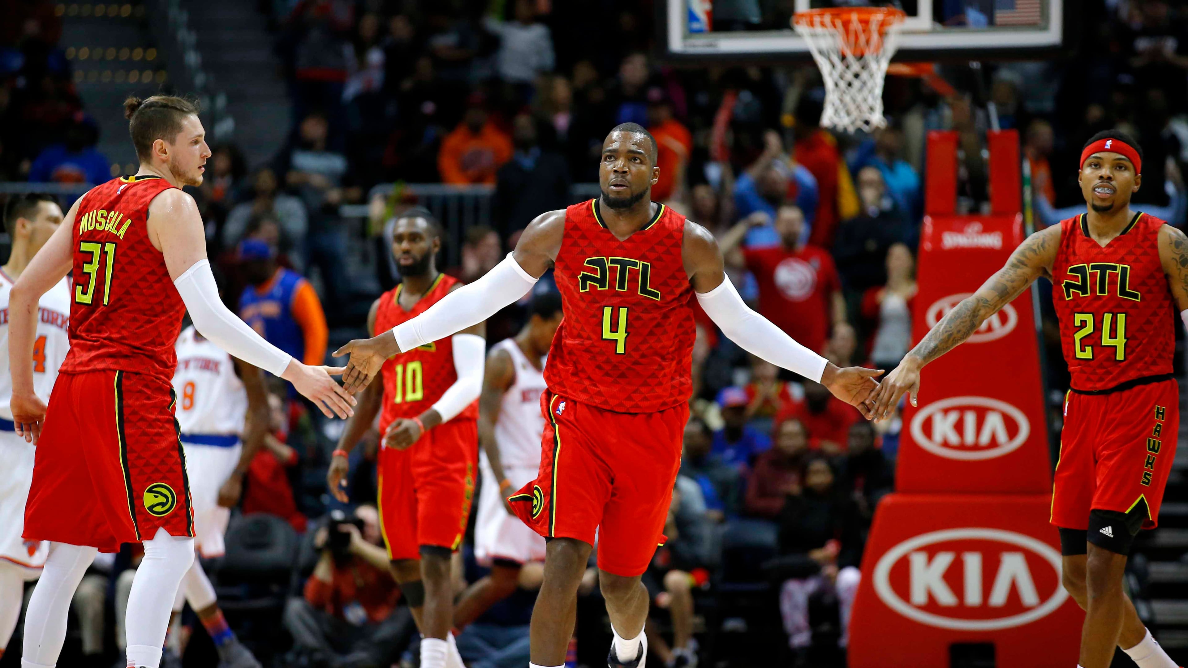 Atlanta Hawks forward Paul Millsap (4) reacts with forward Mike Muscala (31) and forward Kent Bazemore (24) in the fourth overtime of an NBA basketball game against the New York Knicks on Sunday, Jan. 29, 2017, in Atlanta. The Hawks won the game in the fourth overtime 142-139. (AP Photo/Todd Kirkland)