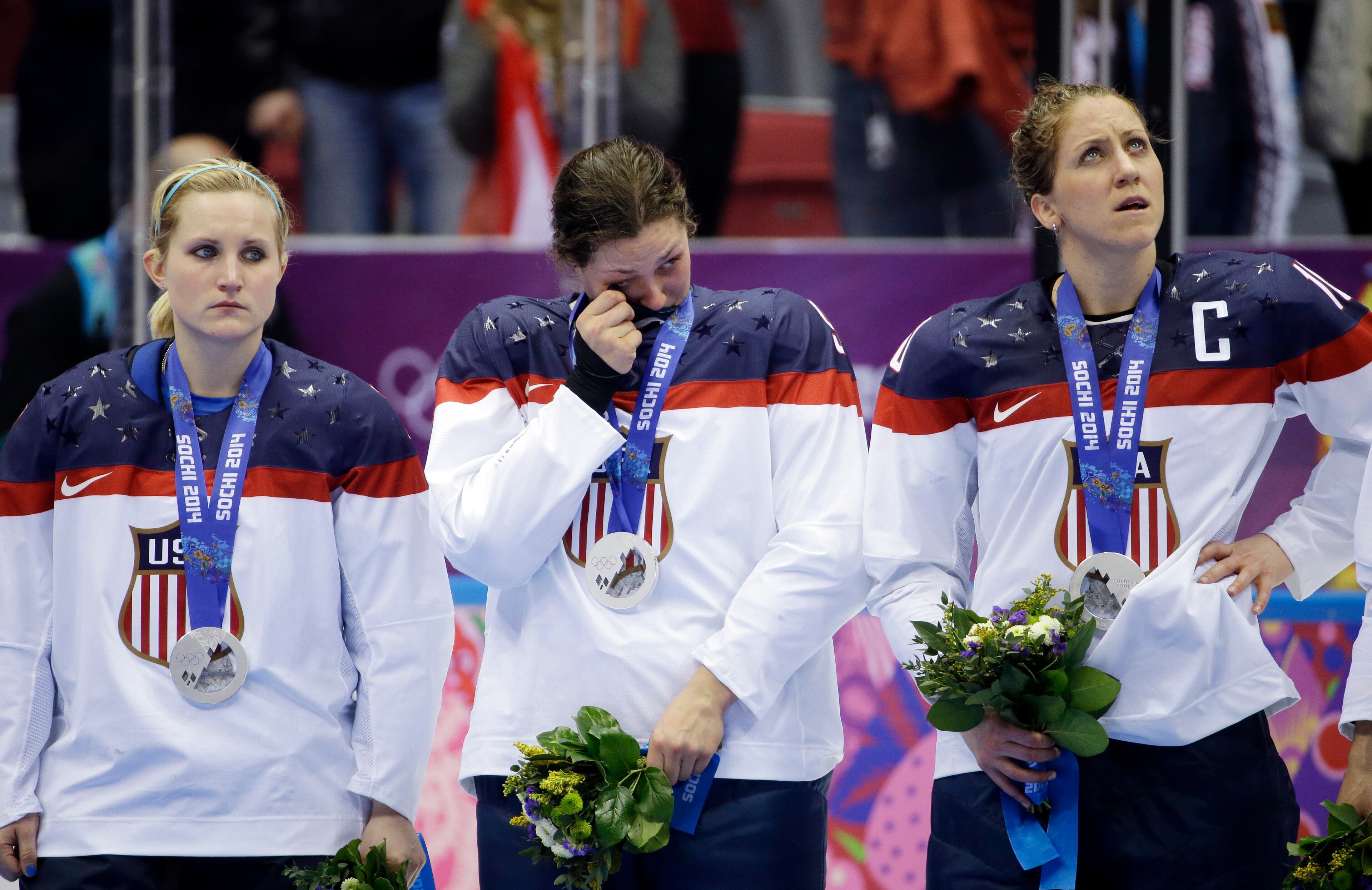 USA players react after losing the gold medal women's ice hockey game to Canada 3-2 in overtime at the 2014 Winter Olympics, Wednesday, Feb. 19, 2014, in Sochi, Russia. (AP Photo/David Goldman)