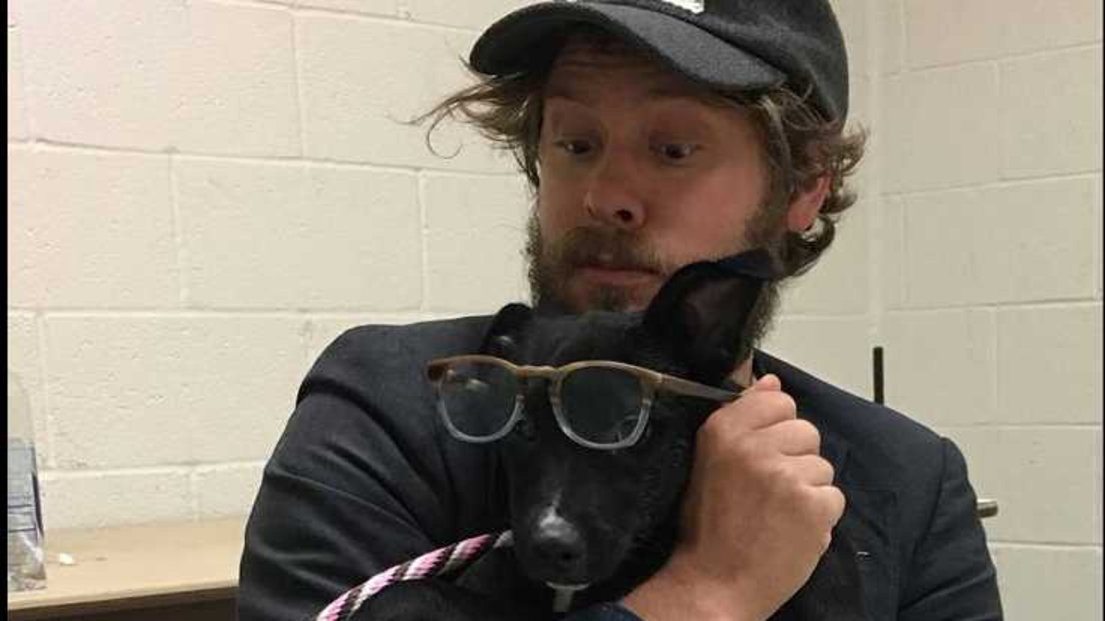 Wesley Schultz of The Lumineers cuddles with a dog at the Georgia SCPA in Suwanee.