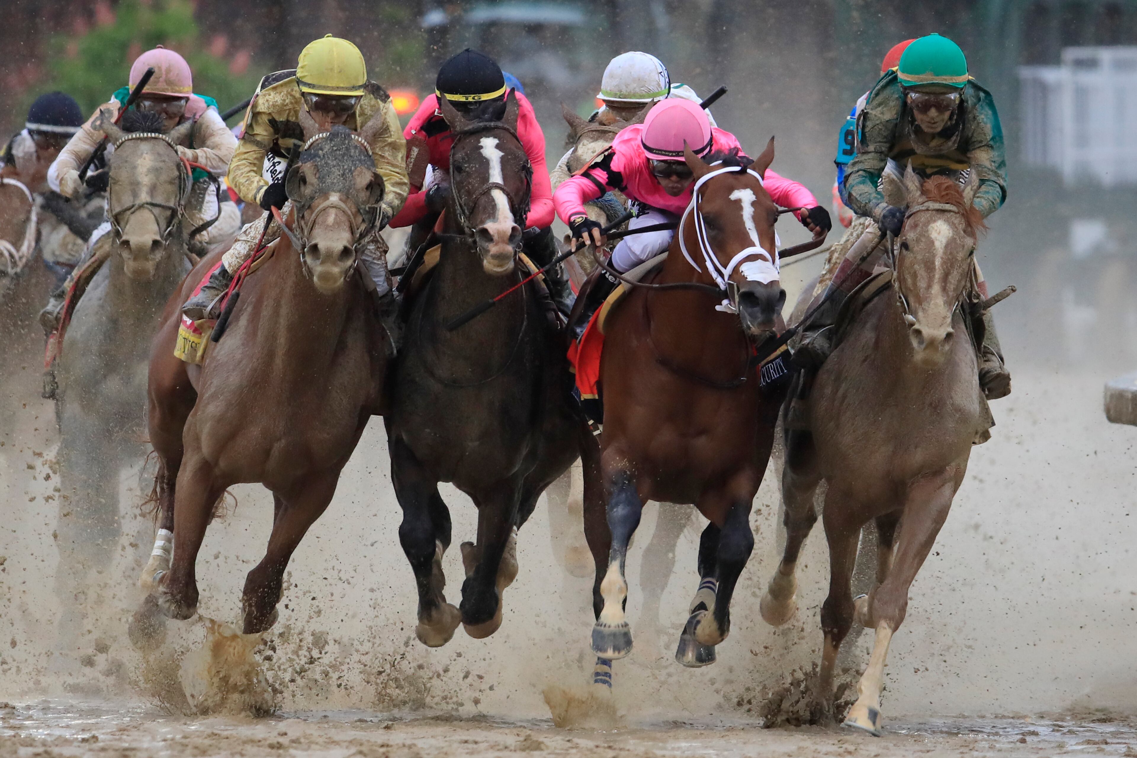 Country House #20, ridden by jockey Flavien Prat, War of Will #1, ridden by jockey Tyler Gaffalione , Maximum Security #7, ridden by jockey Luis Saez and Code of Honor #13, ridden by jockey John Velazquez fight for position in the final turn during the 145th running of the Kentucky Derby at Churchill Downs on May 04, 2019 in Louisville, Kentucky. (Photo by Andy Lyons/Getty Images)