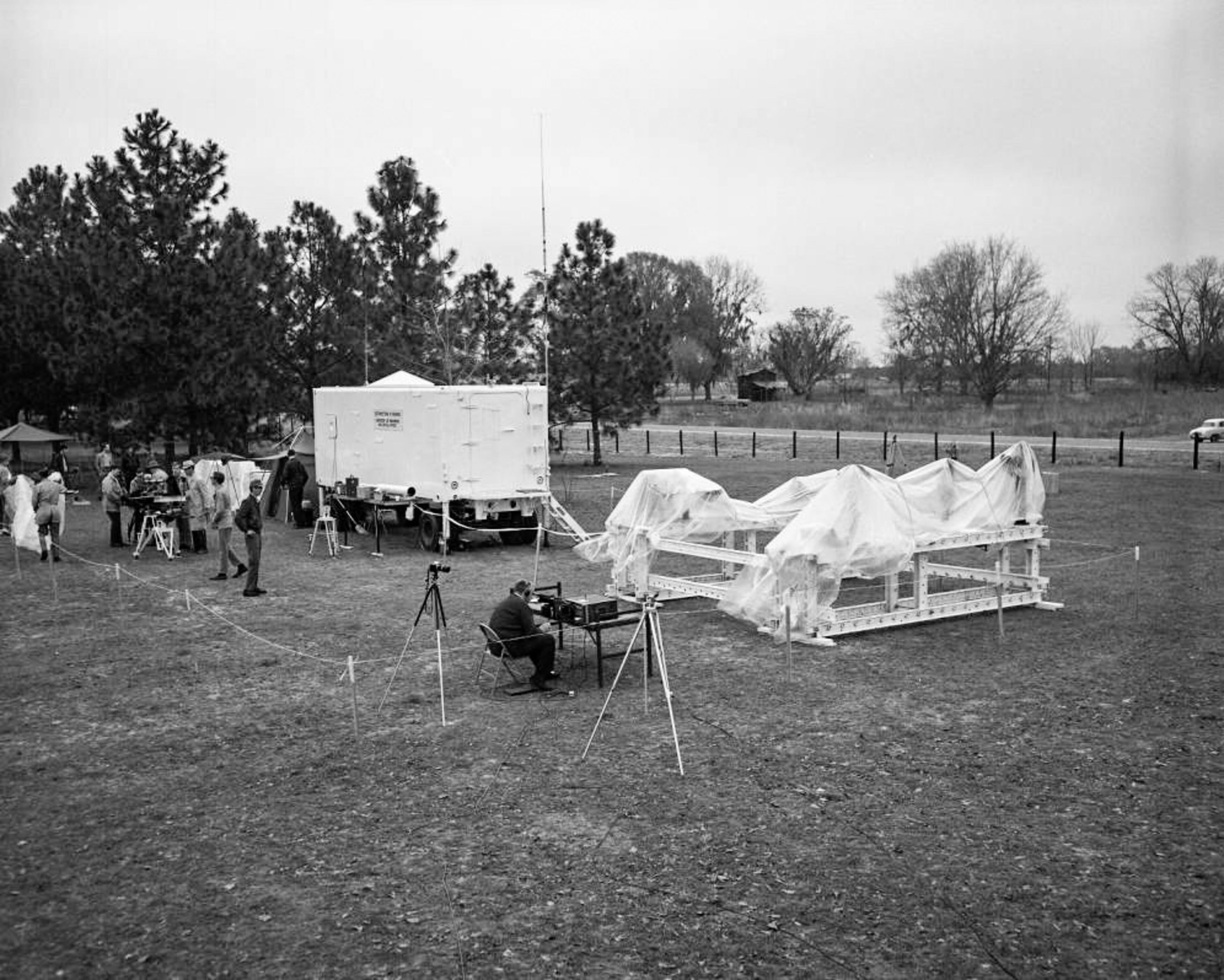 Astronomers at a solar eclipse viewing area with telescopes and other equipment, March 7, 1970.
