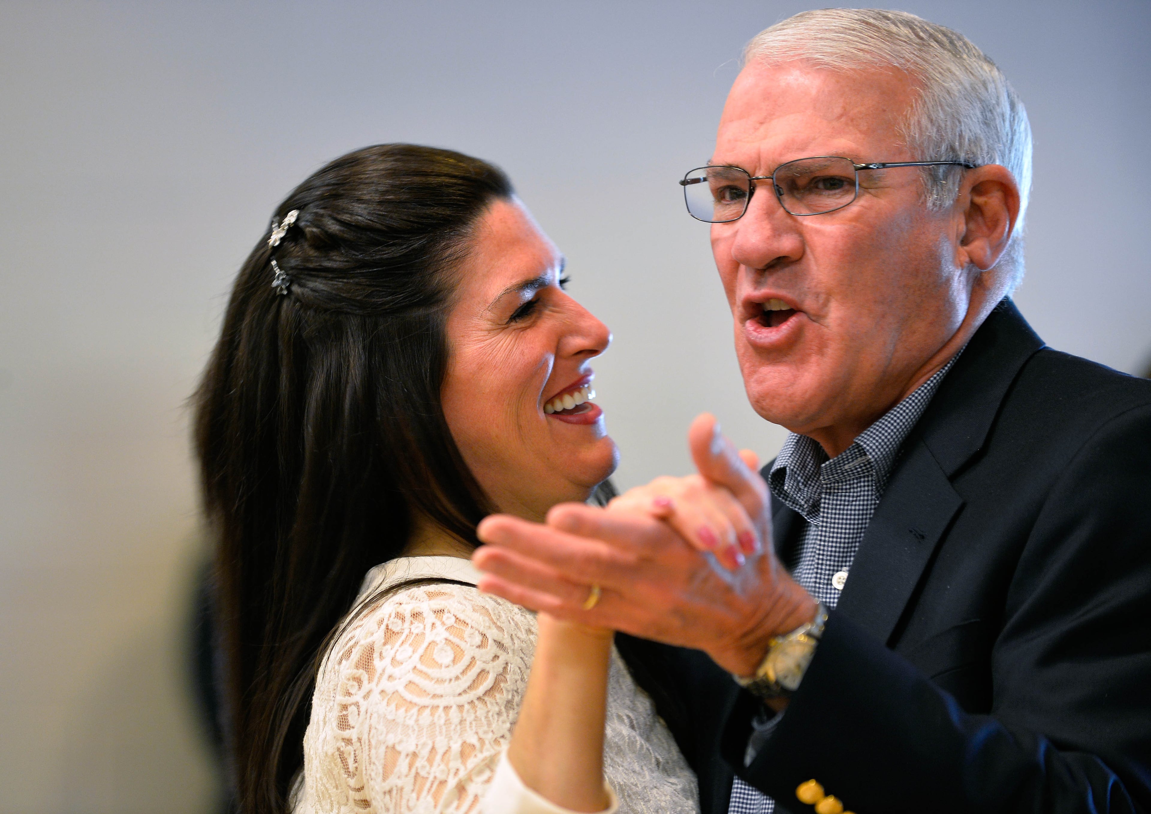 Joseph Trapp, right, joins his newlywed daughter Katharine Serrano for a dance after she was officially married to husband Victor on Saturday, Dec. 13, 2014, in Norcross, Ga. Gwinnett judges officiated the mass wedding ceremony for 30 couples that also featured a reception with a DJ, a photo booth and official wedding pictures for the grooms, brides, and their families. David Tulis/AJC Special