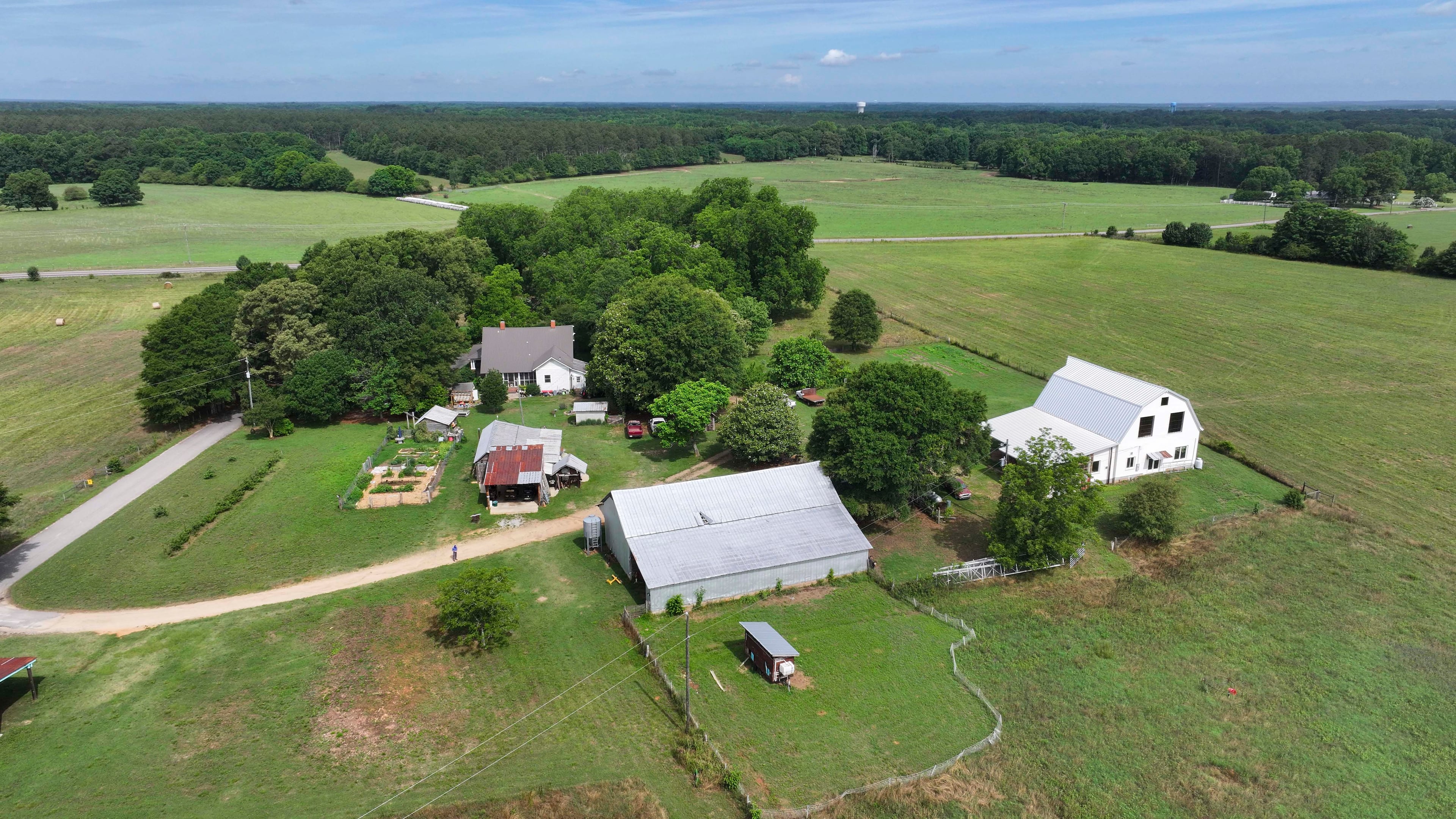 An aerial image shows the Breedlove family farm near Watkinsville in Oconee County on Thursday, May 29, 2026. A proposed highway bypass would cut through the 350-acre property. (Miguel Martinez/AJC)