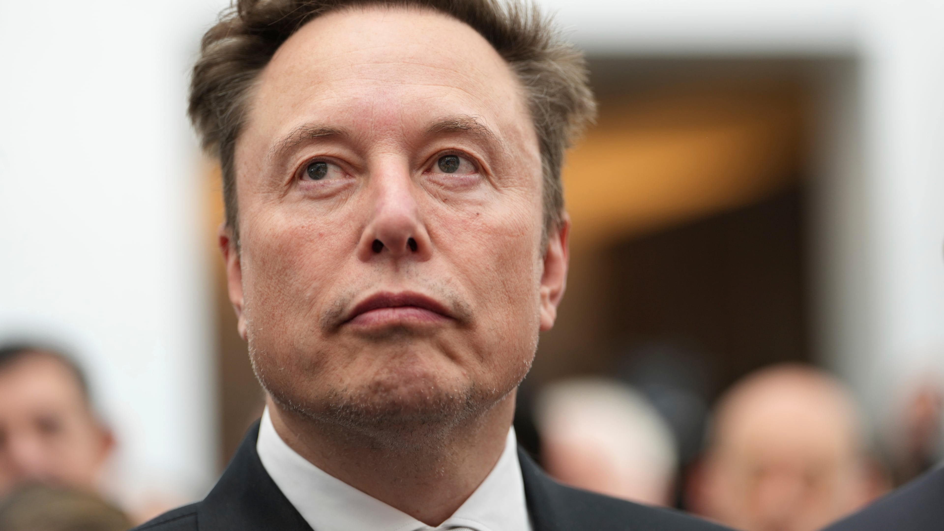 FILE - Elon Musk listens as President Donald Trump speaks during an event at the U.S. Institute of Peace, Oct. 8, 2026, in Washington. (AP Photo/Julia Demaree Nikhinson, File)