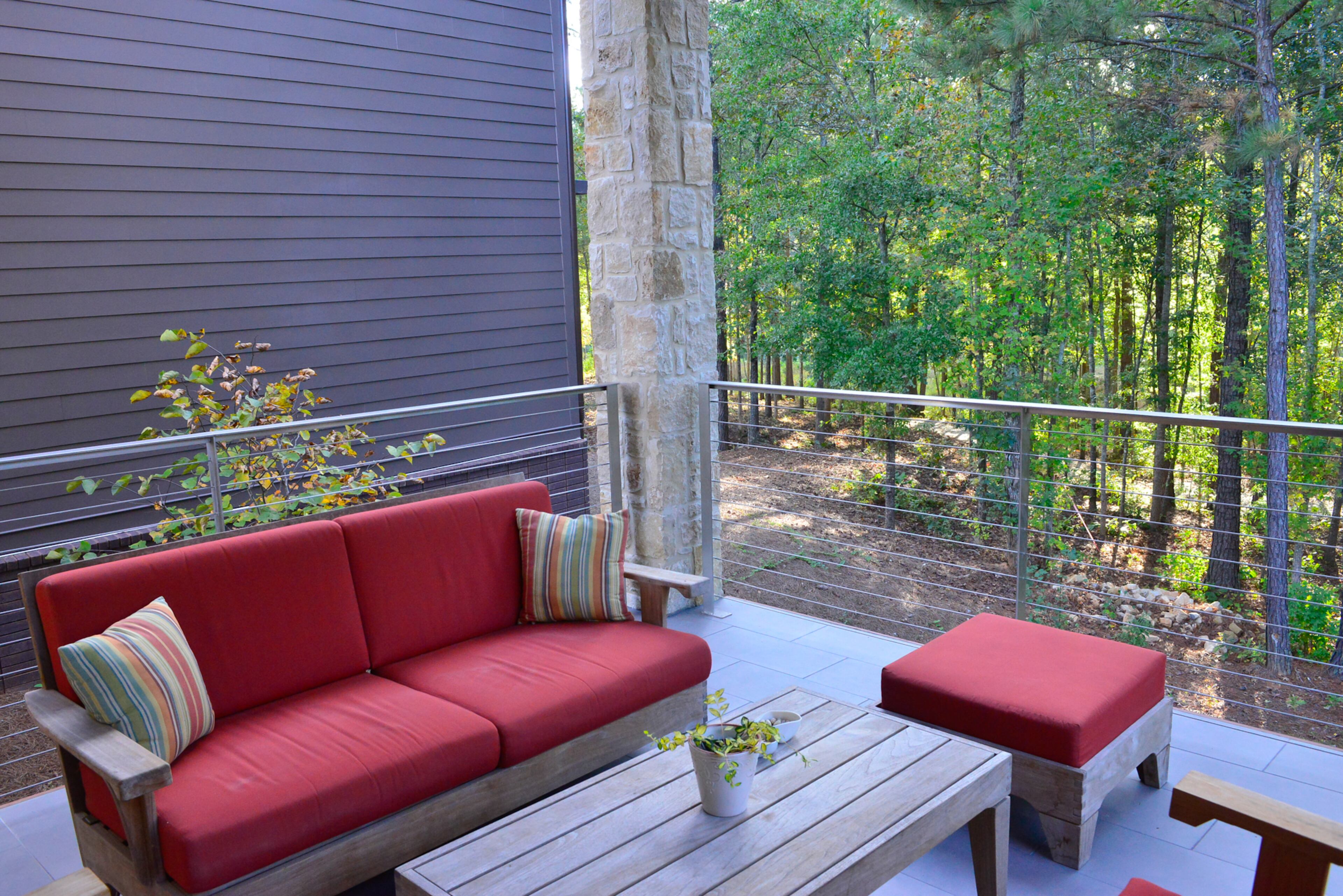The home and patio are surrounded by nature.