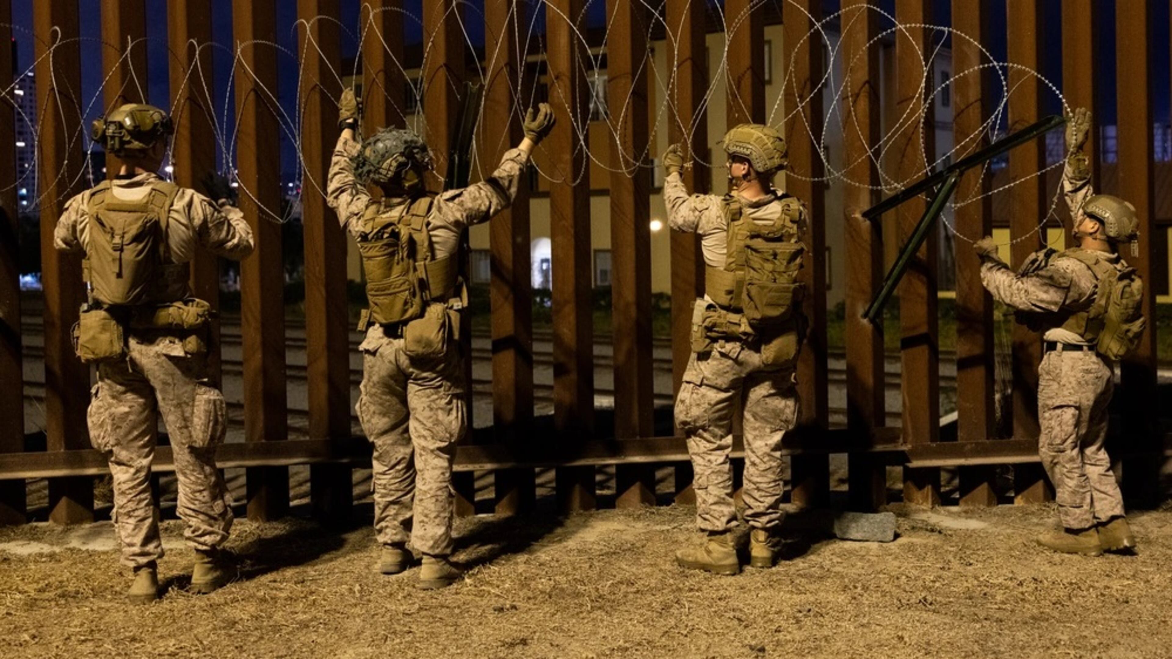 U.S. Marines with 1st Combat Engineer Battalion, 1st Marine Division, place concertina wire along the southern border near San Ysidro, California, on Jan. 25, 2025. (U.S. Marine Corps photo by Sgt. Kyle Chan)