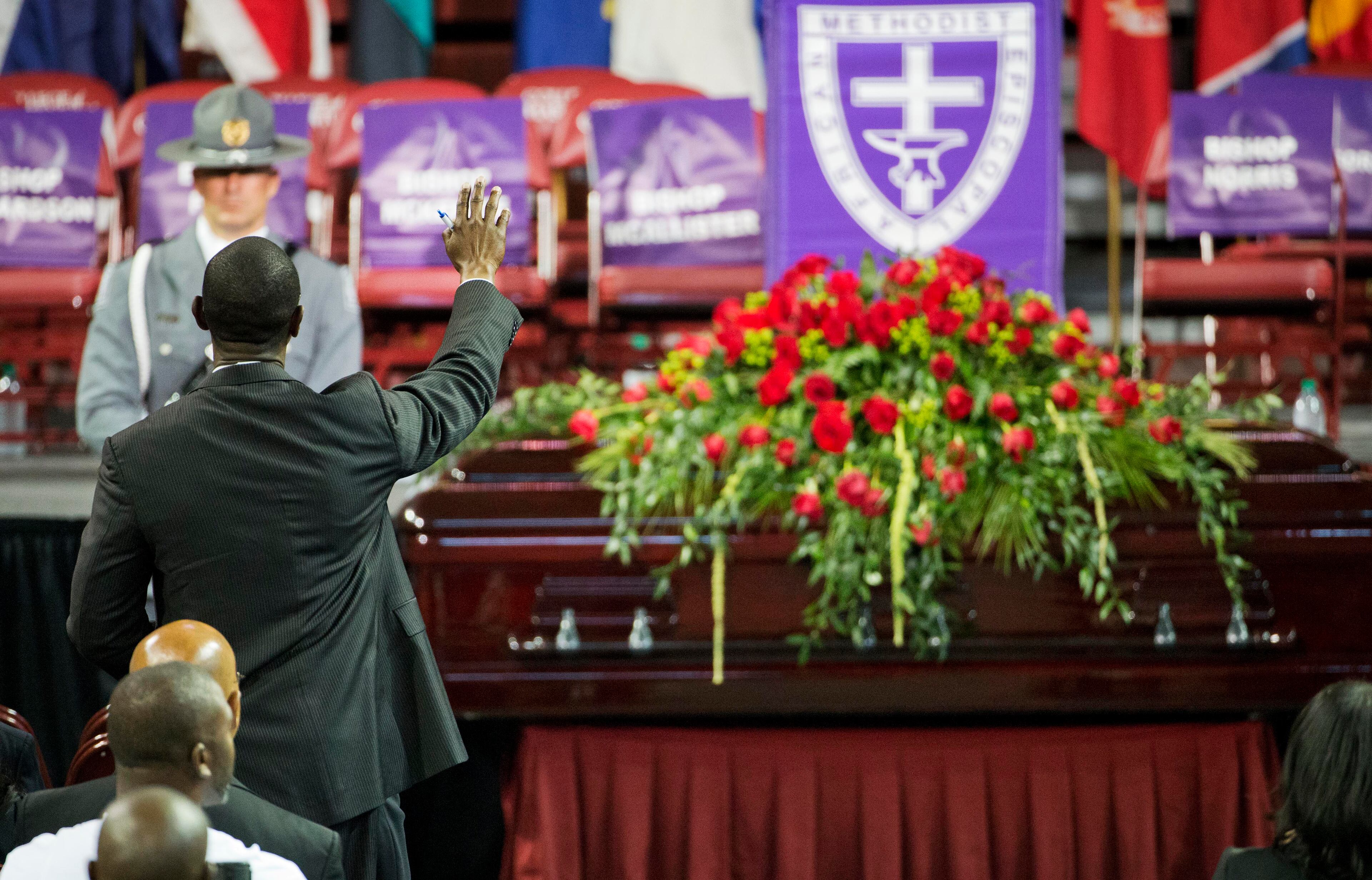A mourner prays next to the casket of Sen. Clementa Pinckney during his funeral service, Friday, June 26, 2015, in Charleston, S.C. President Barack Obama will deliver the eulogy at Pinckney's funeral Friday at College of Charleston's TD Arena near the Emanuel AME Church, the scene of last week's shooting. (AP Photo/David Goldman)