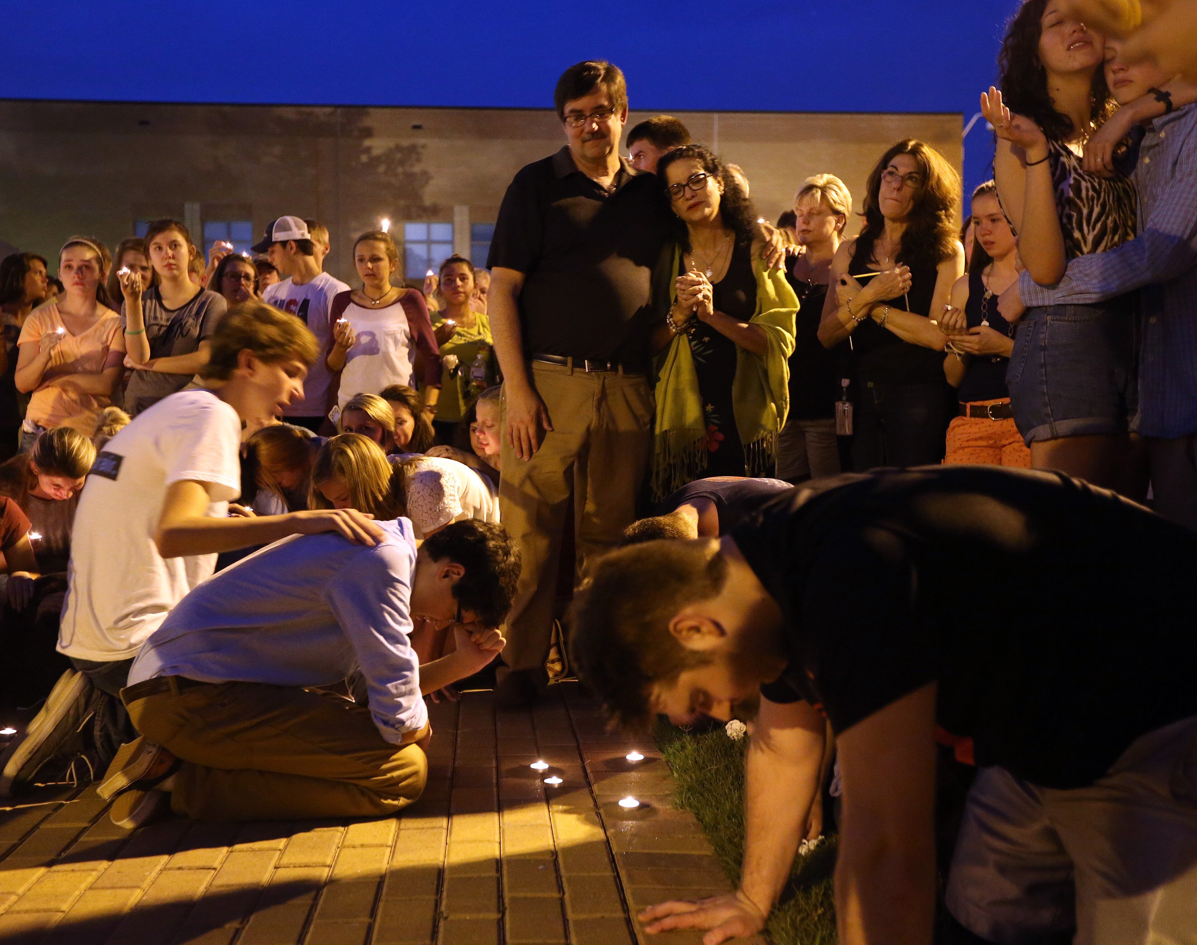 May 28, 2014 Woodstock: Friends of Lucy Boettcher pray during a vigil for the Etowah High senior Wednesday evening May 28, 2014. Boettcher died Tuesday night in a car crash on I-285. BEN GRAY / BGRAY@AJC.COM