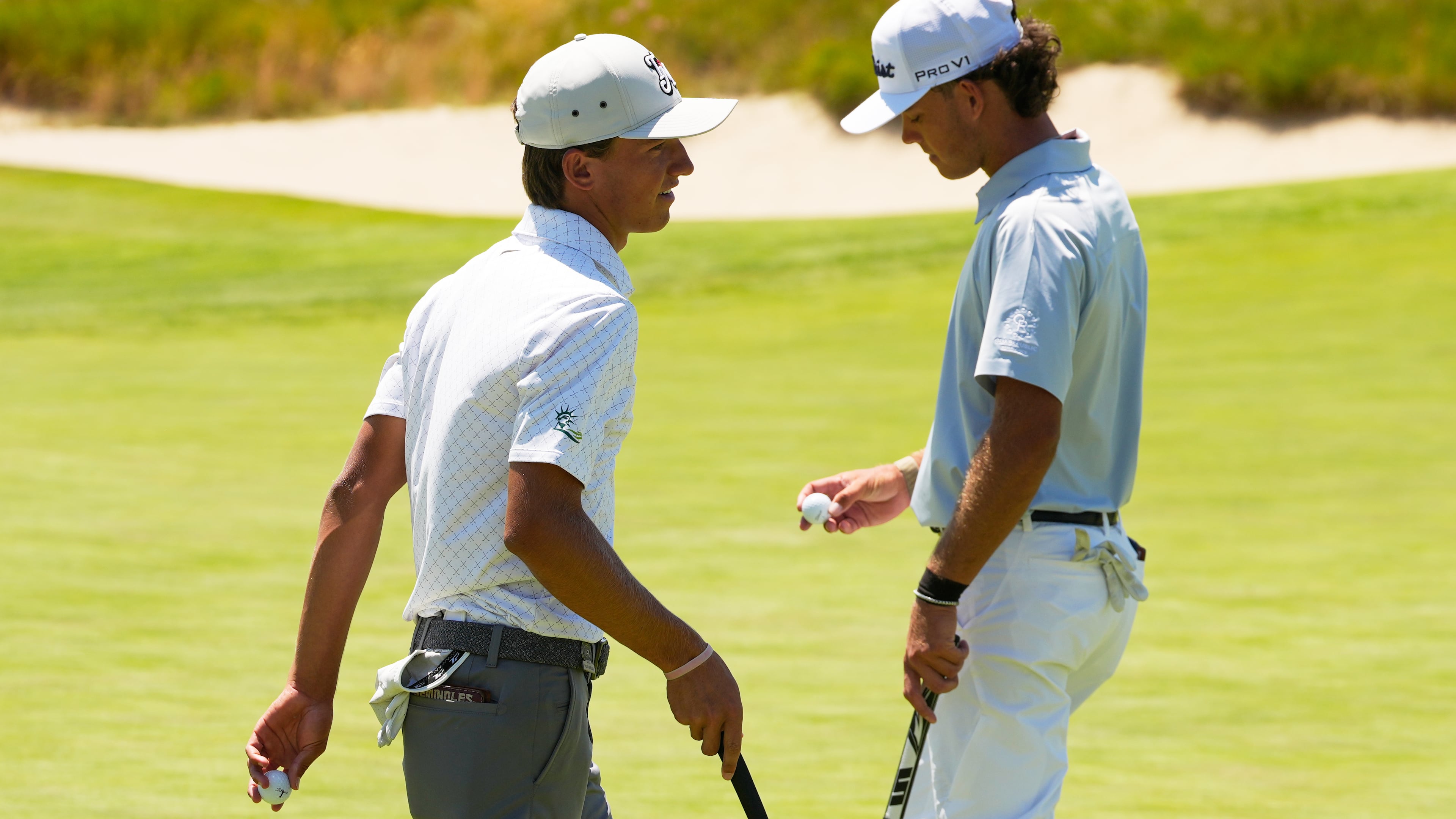 Miles Russell and Jackson Koivu walk on the 14th hole during the third round of the U.S. Open golf tournament at Shinnecock Hills Golf Club in Southampton, N.Y., Saturday, June 20, 2026.(AP Photo/Seth Wenig)