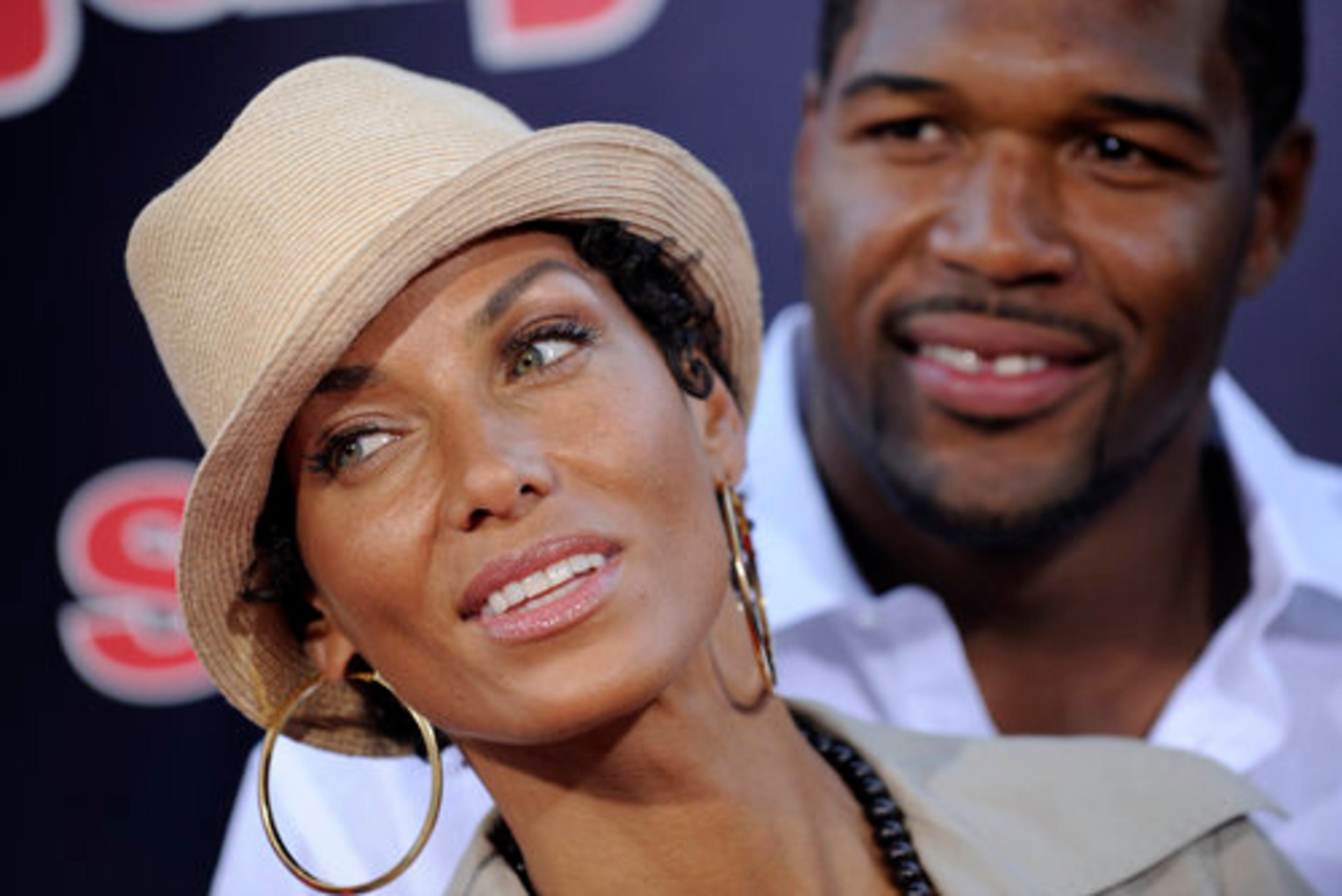 What do you do after divorcing a comedian-actor? If you're Nicole Mitchell, Eddie Murphy's ex, you step out with former New York Giants football player Michael Strahan.