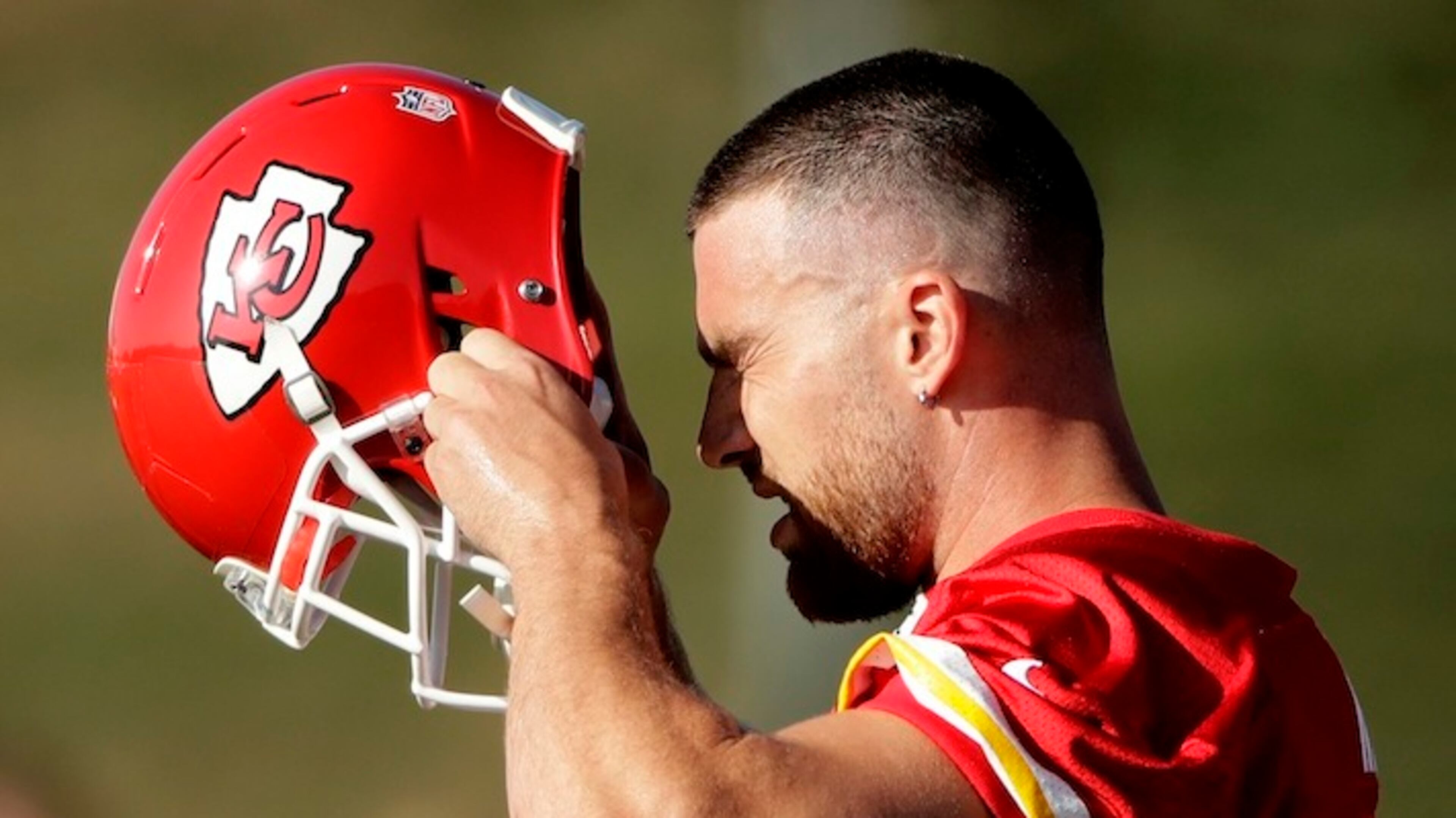 Kansas City Chiefs tight end Travis Kelce (87) puts on his helmet during NFL football training camp Saturday, July 29, 2017, in St. Joseph, Mo. (AP Photo/Charlie Riedel)