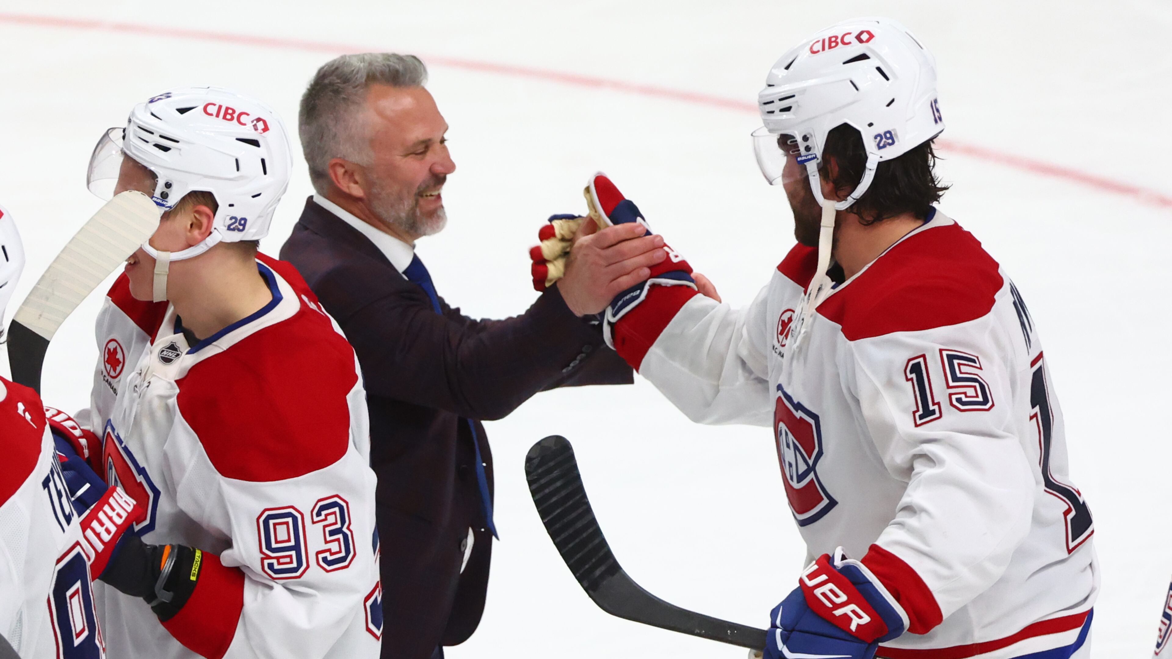 Montreal Canadiens head coach Martin St. Louis shakes hands with Montreal Canadiens center Alex Newhook (15) following the overtime period in Game 7 of a second-round NHL hockey Stanley Cup playoff series against the Buffalo Sabres, Monday, May 18, 2026, in Buffalo, N.Y. (AP Photo/Jeffrey T. Barnes)