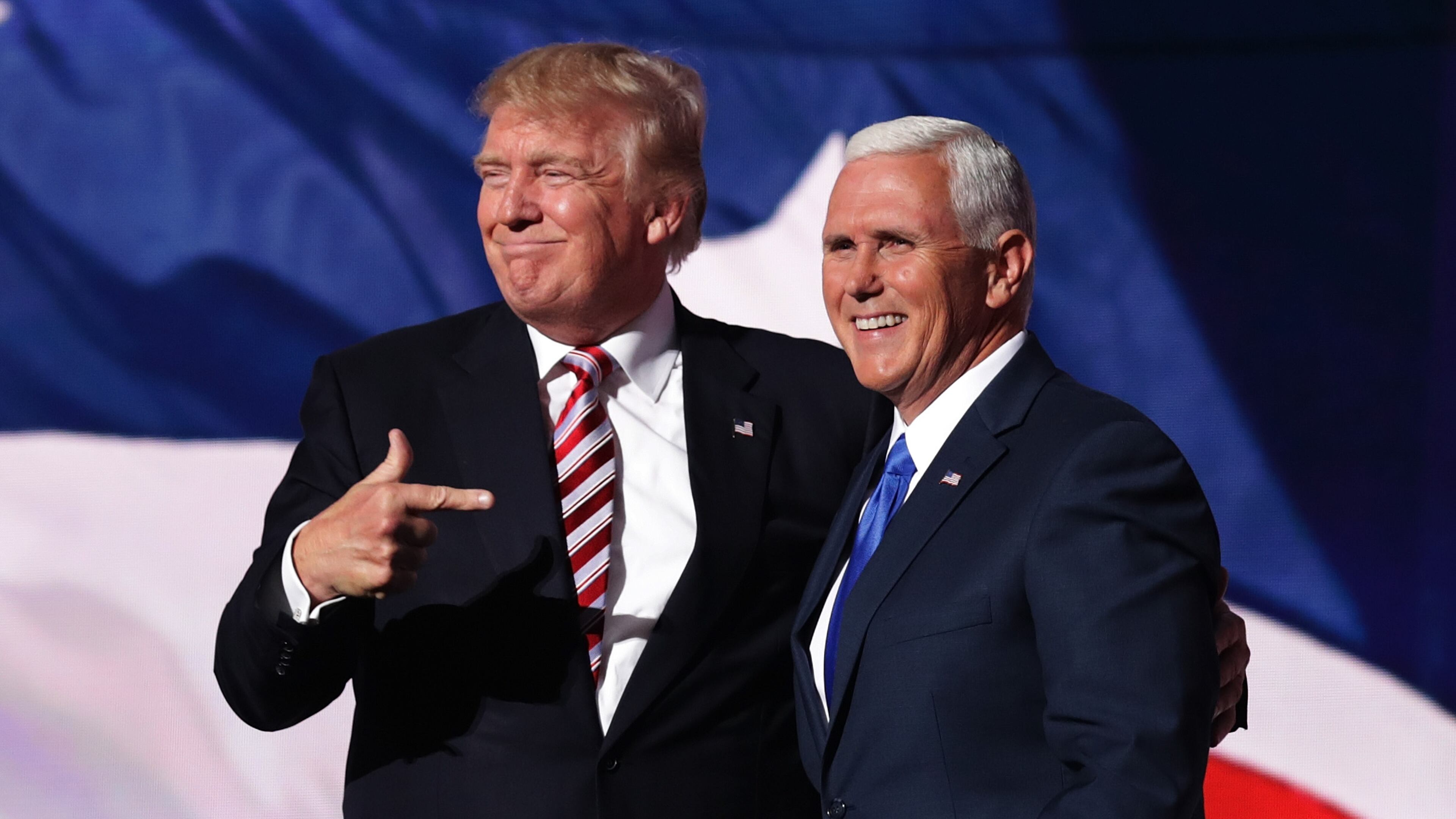 CLEVELAND, OH - JULY 20: Republican presidential candidate Donald Trump stands with Republican vice presidential candidate Mike Pence and acknowledge the crowd on the third day of the Republican National Convention on July 20, 2016 at the Quicken Loans Arena in Cleveland, Ohio. Republican presidential candidate Donald Trump received the number of votes needed to secure the party's nomination. An estimated 50,000 people are expected in Cleveland, including hundreds of protesters and members of the media. The four-day Republican National Convention kicked off on July 18. (Photo by Chip Somodevilla/Getty Images)