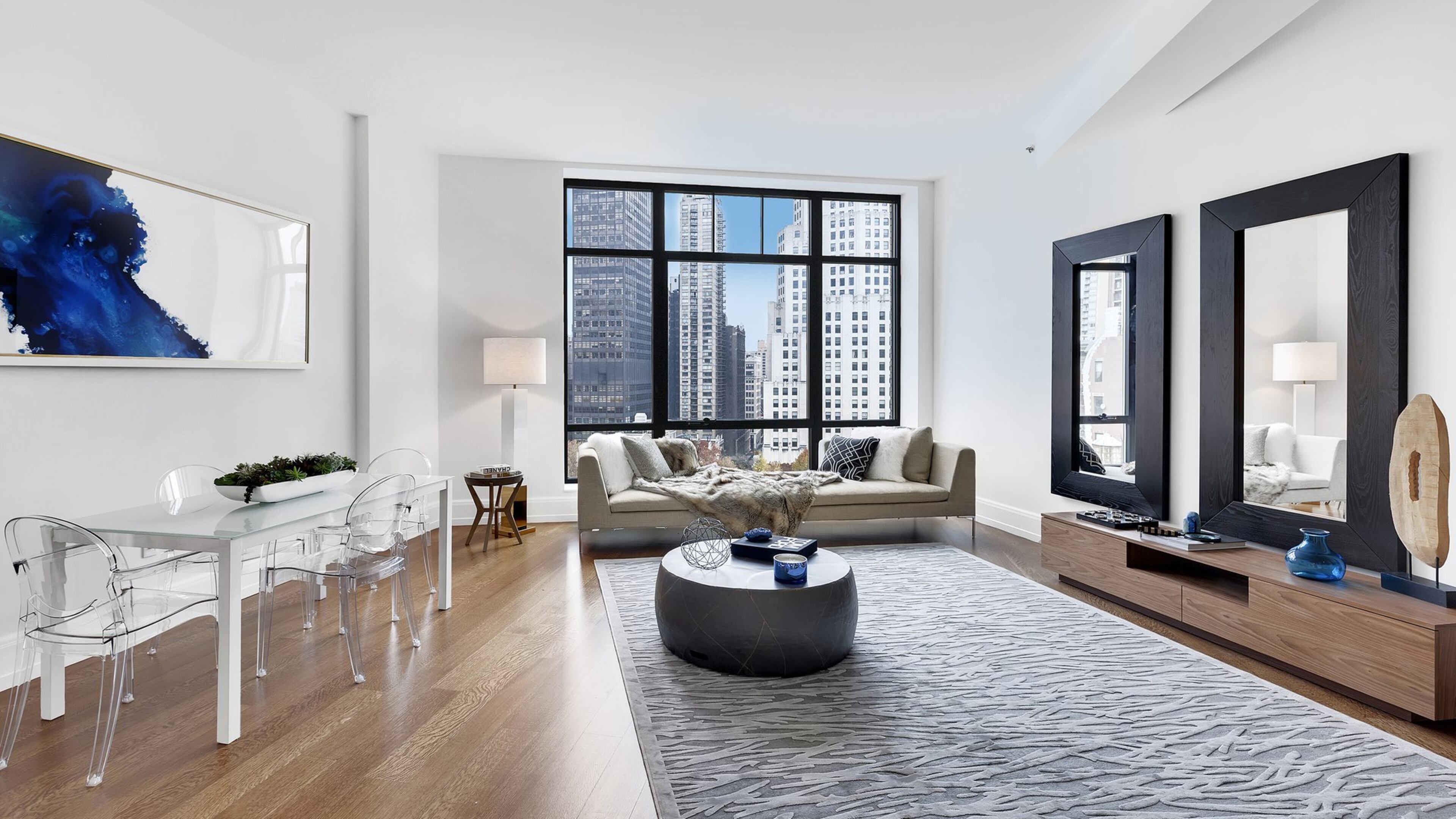 Inexpensive oversized mirrors help frame this living room space. (Handout/TNS)